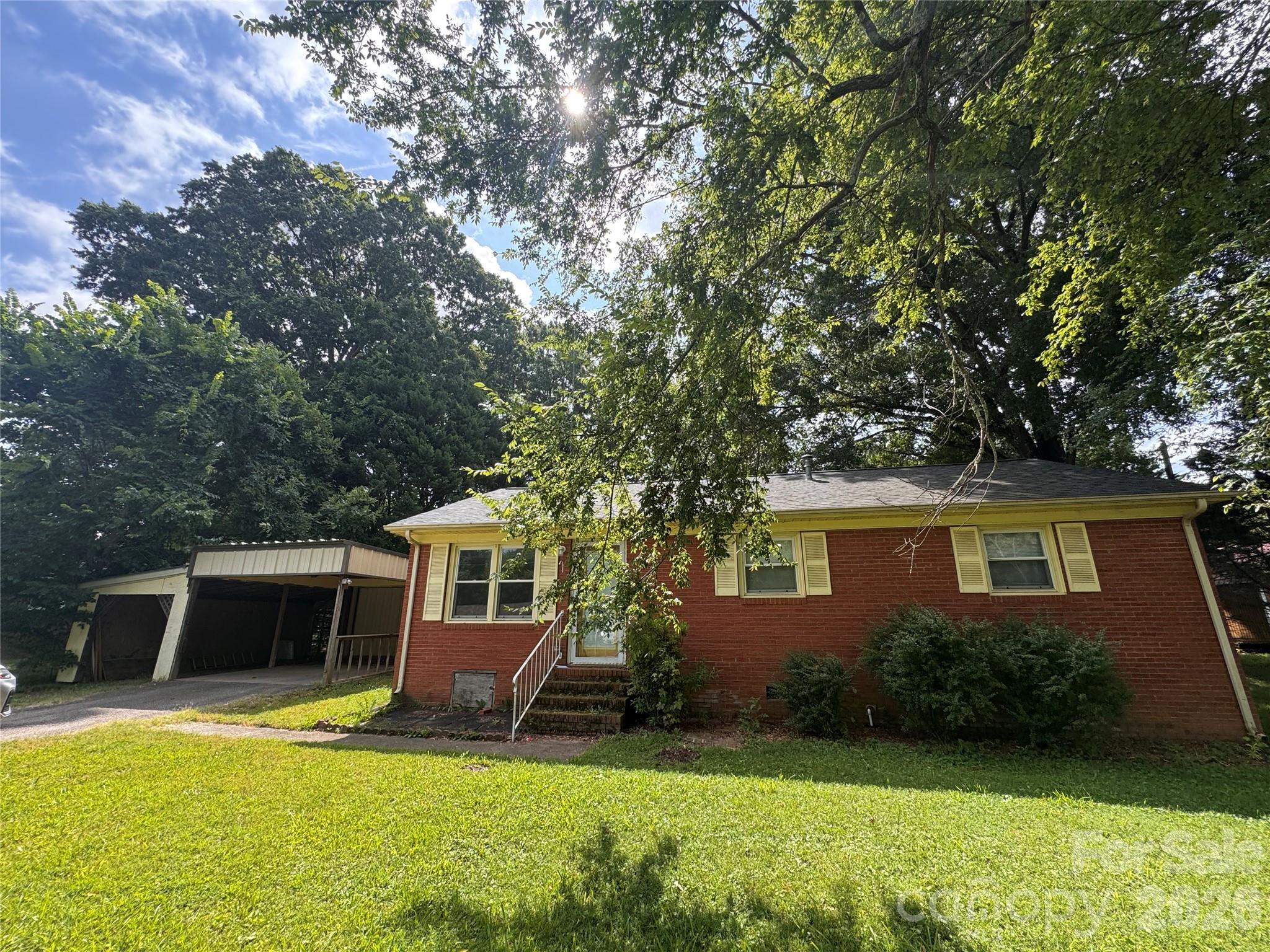 Charming all-brick ranch on a 0.34-acre lot in Indian Trail — NO HOA! This home is tucked back at the end of the street.  You'll love the privacy and the flat backyard.  With new interior paint including a fresh look for the kitchen cabinets, this home is worth the look for the money! Enjoy the large deck and bonus storage buildings, plus an attached carport.  Endless possibilities await. Established neighborhood just off Old Monroe Rd with easy I-485 access and Union County schools. A solid home — ideal for first-time buyers, downsizers, or investors. Bring your finishing touches and make it your own!  With multiple Down Payment Assistance Programs identified through Canopy's partnership with DPR, why rent?