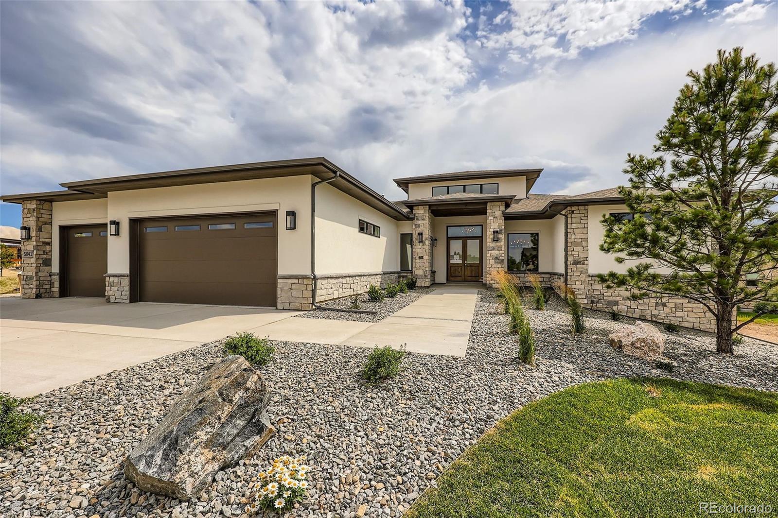 This exquisite Mountain Contemporary ranch-style home by renowned builder Gladstone Custom Homes is located in the prestigious Timbers at The Pinery subdivision in Parker, Colorado, offering a perfect blend of luxury, comfort, and stunning natural surroundings. The main level features two spacious bedrooms, including a serene primary suite designed for relaxation and privacy. The finished basement adds two additional bedrooms, a large recreation area complete with a cozy fireplace, an exercise room, and ample storage space with potential for future expansion, making it ideal for flexible living and entertaining. The home boasts custom, high-end finishes throughout, including designer appliances that enhance the modern kitchen’s functionality and style. The attention to detail is evident in every corner, from sleek cabinetry to premium fixtures, creating an elegant yet inviting atmosphere. Included in the purchase price is a full landscaping package, ensuring the outdoor spaces are as thoughtfully designed as the interiors, perfectly complementing the mountain contemporary aesthetic. Residents of Timbers at The Pinery enjoy optional access to the exceptional amenities of The Pinery Country Club and The Club at Pradera. These private clubs offer premier golf courses, tennis courts, swimming pools, fitness centers, and vibrant social calendars, providing a rich lifestyle experience. The Pinery Country Club recently completed a multi-million-dollar renovation, enhancing its clubhouse, dining, and recreational facilities to foster a warm, social environment for members and their families. Set amidst breathtaking mountain views and tranquil open spaces, this home provides a unique opportunity to live in one of Douglas County’s most sought-after communities. With its seamless combination of rustic charm and contemporary elegance, plus access to world-class amenities, this Mountain Contemporary ranch home in Timbers at The Pinery represents the pinnacle of Colorado living.