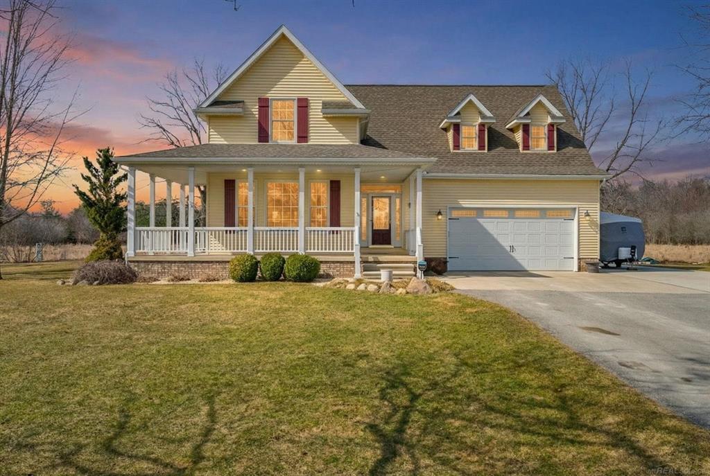 COUNTRY PERFECTION! Beautiful farmhouse-style home 2,200 sq ft with 4 bedrooms and 2.5 baths in a scenic 9.997 Acre country setting. A 42-ft wraparound porch welcomes you into a bright living room with cathedral ceiling and gas fireplace. Formal dining room features hard wood floors and a bay window. Spacious kitchen includes custom cherry cabinets, granite countertops, hardwood flooring, upgraded appliances, and a sunny breakfast area overlooking the countryside. Main floor primary suite offers a walk-in closet, bay window, and private 4-piece bath. Main level also includes a powder room and laundry room. Upstairs features two additional bedrooms, a full bath, and a bonus room that can serve as a fourth bedroom or flex space. Full basement with recreation area and ample storage. Attached 2.5-car garage with an 8' door plus an additional 24'x36' detached garage . Outdoor features include paved driveway, 16'x 57' cement RV pad, 10'x14' deck, 16'x32' patio, scenic pond, and approximately  ½ mile of groomed walking paths. Property is abundant with wildlife and mature fruit, nut, evergreen, and hardwood trees.