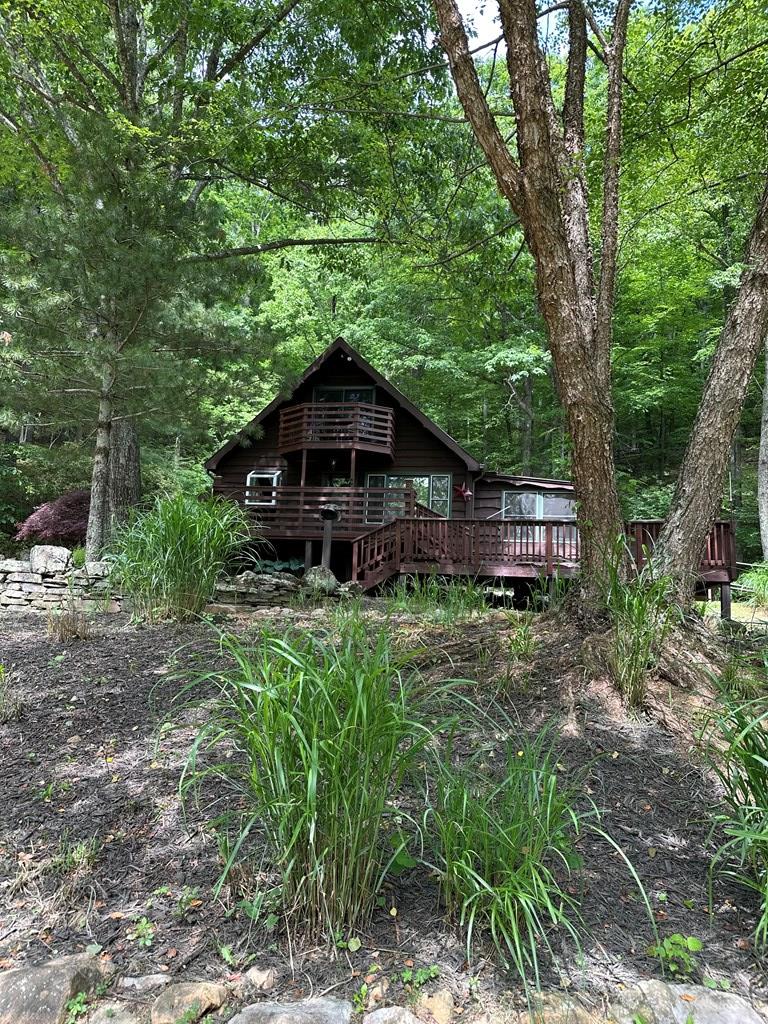 Mountain Cabin Retreat on 4.6 Wooded Acres – Ideal Full-Time Home, Private Getaway, or Airbnb Investment Escape to the mountains with this charming cabin retreat nestled on 4.6 mostly wooded acres at an elevation of approximately 3,500 feet. Whether you are searching for your first home, a peaceful private getaway, or an income-producing Airbnb opportunity, this beautifully maintained property offers the perfect combination of comfort, privacy, and mountain charm.  Offering approximately 1,623 square feet, this home features 3 bedrooms and 1.5 baths with a warm and inviting layout. The fully appointed kitchen includes granite countertops, appliances, abundant cabinetry, and a custom wood-burning stove that adds rustic character and cozy ambiance. Just off the kitchen is a versatile bonus room perfect for a pantry, office, or hobby space.  The kitchen flows seamlessly into the spacious great room, providing plenty of room for relaxing or entertaining guests. One of the home's standout features is the enclosed sunroom overlooking a picturesque pond filled with colorful Koi fish of various sizes, creating a peaceful setting year-round.  Down the hallway you will find the main bathroom, a customized primary bedroom, and a large laundry/utility room with extra storage space. Upstairs offers two additional bedrooms and a convenient half bath, ideal for family or overnight guests.  Step outside onto the expansive newly stained deck and enjoy cool mountain air, scenic surroundings, and ultimate privacy. The grounds have been beautifully landscaped and include four well-maintained outbuildings perfect for tools, gardening supplies, or additional storage.  This property has been exceptionally well cared for and comes partially furnished, making it move-in ready and an excellent turnkey short-term rental opportunity. Private and secluded, yet located only a few miles from town for shopping, dining, and conveniences.  Properties like this do not come along often.