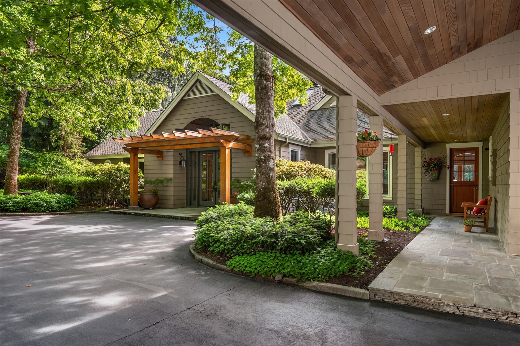 Front entry with wood pergola, glass door, covered porch