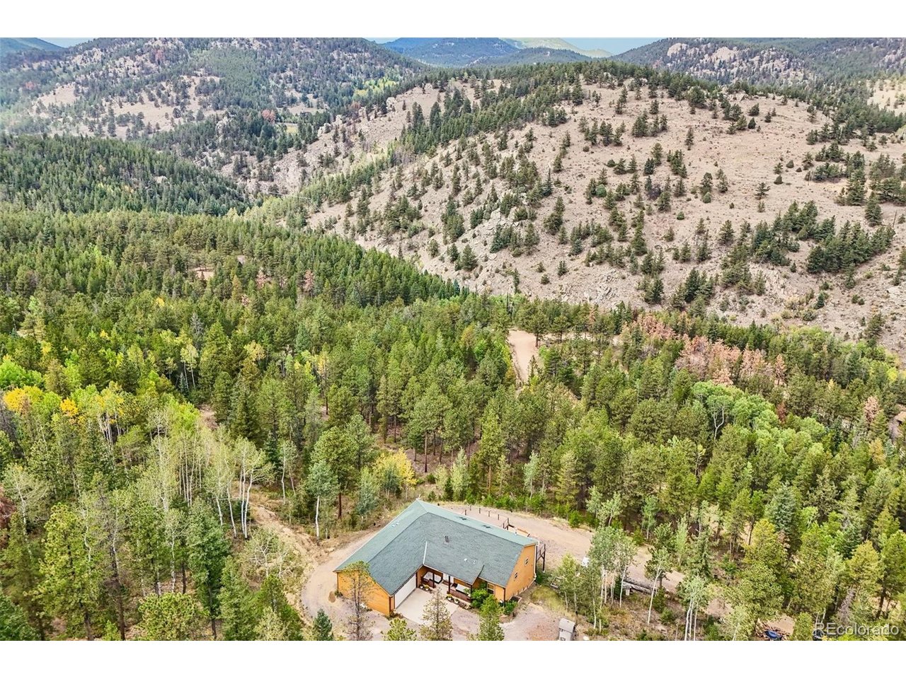 Spectacular mountain home on over 28 private acres. Stunning views of Golden Gate Canyon State Park to the front and Division of Wildlife land in the rear. Soundproofed master suite. Over engineered walls & flooring. Clean in-floor radiant heat powered by a high-efficiency wood-burning boiler system with propane backup. Only $700/yr for propane. Newly added 650 SQ FT Trex Deck, reinforced & designed to hold hot tub. New skylights, fans & blinds. New gutters. New Radon System. New Driveway with 750' of gravel added. New 240V Electric in workshop. Newly converted 2nd primary bathroom with Starphire glass & rain shower. New oven & propane range. This is a spectacular home in a breathtaking location. Surrounded by public lands, close to Black Hawk & Central City casinos, fine dining, brewery, distillery, arcade & museum. Close to Nederland & Eldora Ski Area. Minutes from the Peak to Peak Scenic Byway yet only a short drive to Golden and the city. Private locked gate. Truly a must see property. Home warranty.