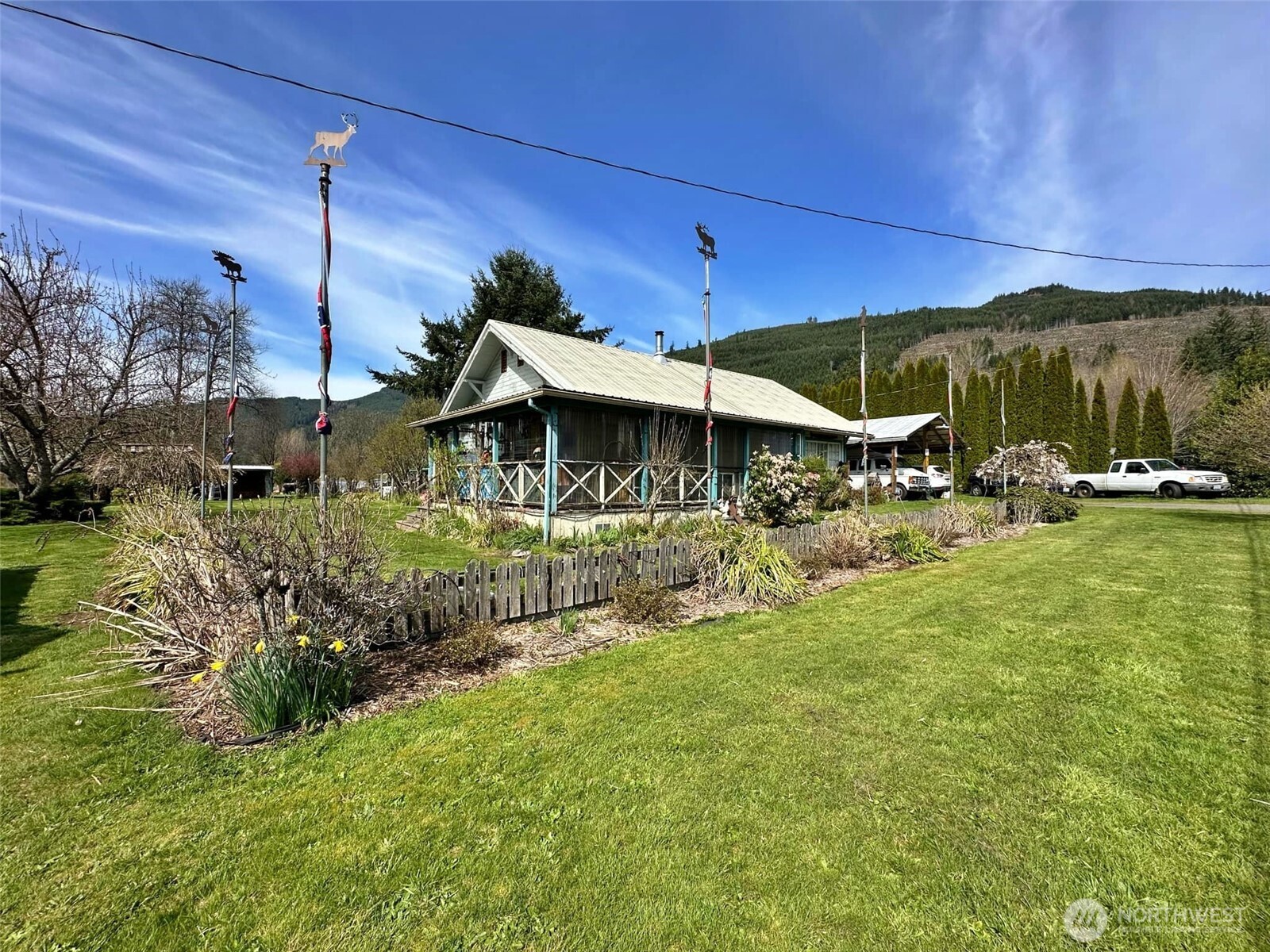 UNIQUE opportunity for a home-based business or future development. Surveyed 2.34 acres on the corner of US Hwy 12 and Martin Rd. Property includes a 1,002 sq ft, 2bd/1ba SFR with divided workshop & double carport plus a screened-in porch for pets and peaceful relaxation. Spectacular landscaping with a fruit & berry orchard, large garden space, greenhouse, and 2 fish ponds complete with beautiful Koi; and zoned irrigation to keep everything green! Detached 742 sq ft, 2bd/1ba rental home for potential rental income. Two historic Kosmos bunkhouses; one turned storefront with a bathroom and the second is storage only. The property is zoned STMU for commercial or residential use in a great location across from the Fire Station & Post Office.