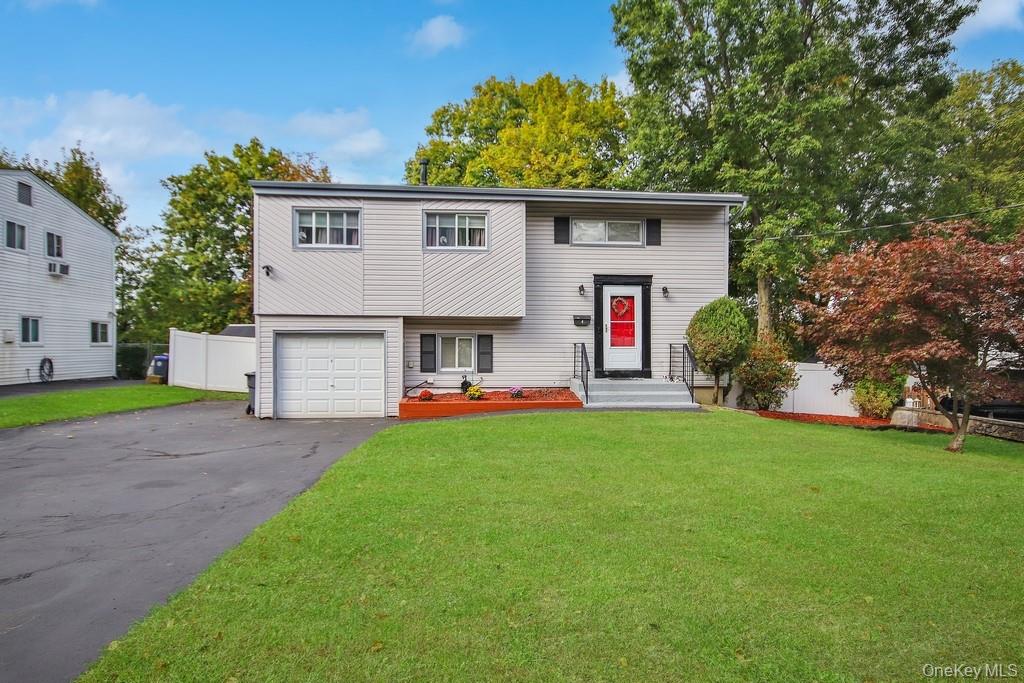 Discover the perfect blend of sought-after location and flexible living in this charming four-bedroom split-level residence. Nestled on a peaceful cul-de-sac in desirable Hartsdale, this home offers the ideal environment for family life, combined with the top-tier education of the Ardsley School District. The home features 4 spacious bedrooms and  (1 full, 2 half) bathrooms to comfortably accommodate your family.
Outside, the property truly shines: An expansive deck off the main living area provides the perfect setting for summer barbecues, alfresco dining, and relaxation.  Enjoy the tranquility of your private, backyard—a safe and beautiful space for children to play, gardening, or simply unwinding after a long day.  Quiet Cul-de-Sac Setting: The safe, low-traffic location ensures a peaceful atmosphere and a wonderful community feel. With its excellent school district, flexible layout, and superb outdoor entertaining space, this Hartsdale gem is an opportunity you won't want to miss.  Schedule your private showing today and start living the exceptional Westchester lifestyle!