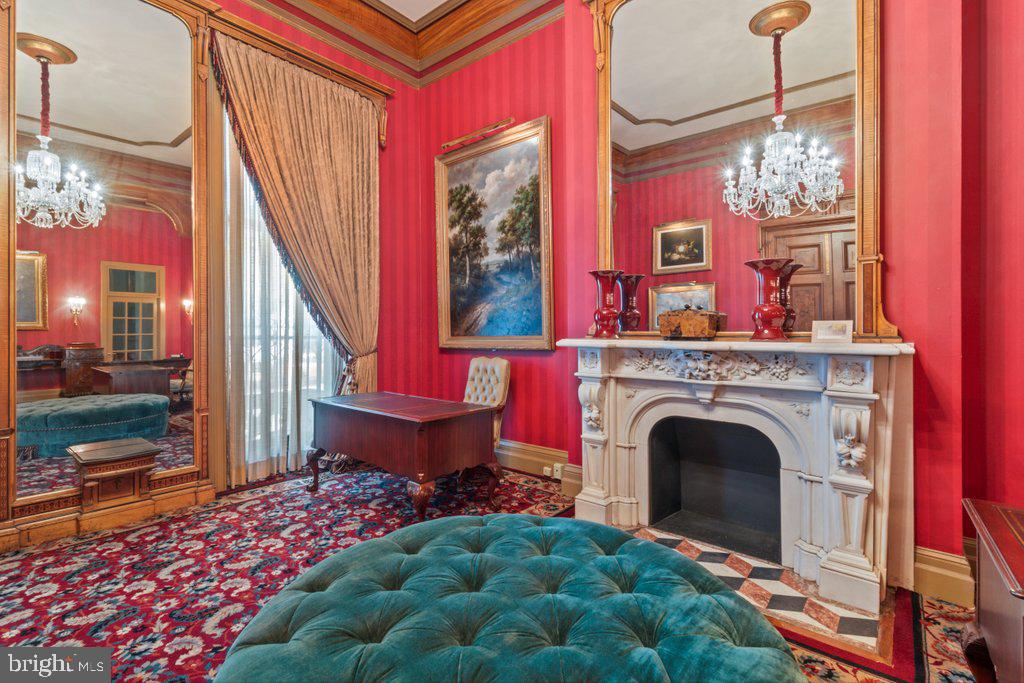 Previously used as a private physician’s office, Unit 14 occupies the parlor level and showcases 14-foot ceilings in the main rooms, with 11-foot ceilings in both the bath and a side room suited for a future kitchen. The space exudes a quiet grandeur, centered around an imported Italian marble mantel installed during a 1990s renovation that blended historic Mount Vernon character with refined European detail.Sunlight streams through 11-foot east-facing windows overlooking Saint Paul Street, filling the rooms with warmth and highlighting the tall doorways, decorative trim, and elegant proportions. While no kitchenette is currently installed, the thoughtful layout includes a room that can easily be adapted into one—offering a seamless path from professional use to residential living.The History: At the heart of Mount Vernon, 1118 and 1120 Saint Paul Street embody Baltimore’s architectural legacy. Designed and once occupied by George A. Frederick — the young prodigy behind Baltimore City Hall and the city’s park system — these brownstones reflect both history and craftsmanship. Now ,for sale within them are five distinct condominium units: dramatic parlor-level suites with soaring ceilings and ornate detail, alongside expansive lower-level spaces with flexible layouts and private entries. Together, they offer owner-users a rare mix of historic pedigree and practical adaptability in Baltimore’s cultural core.