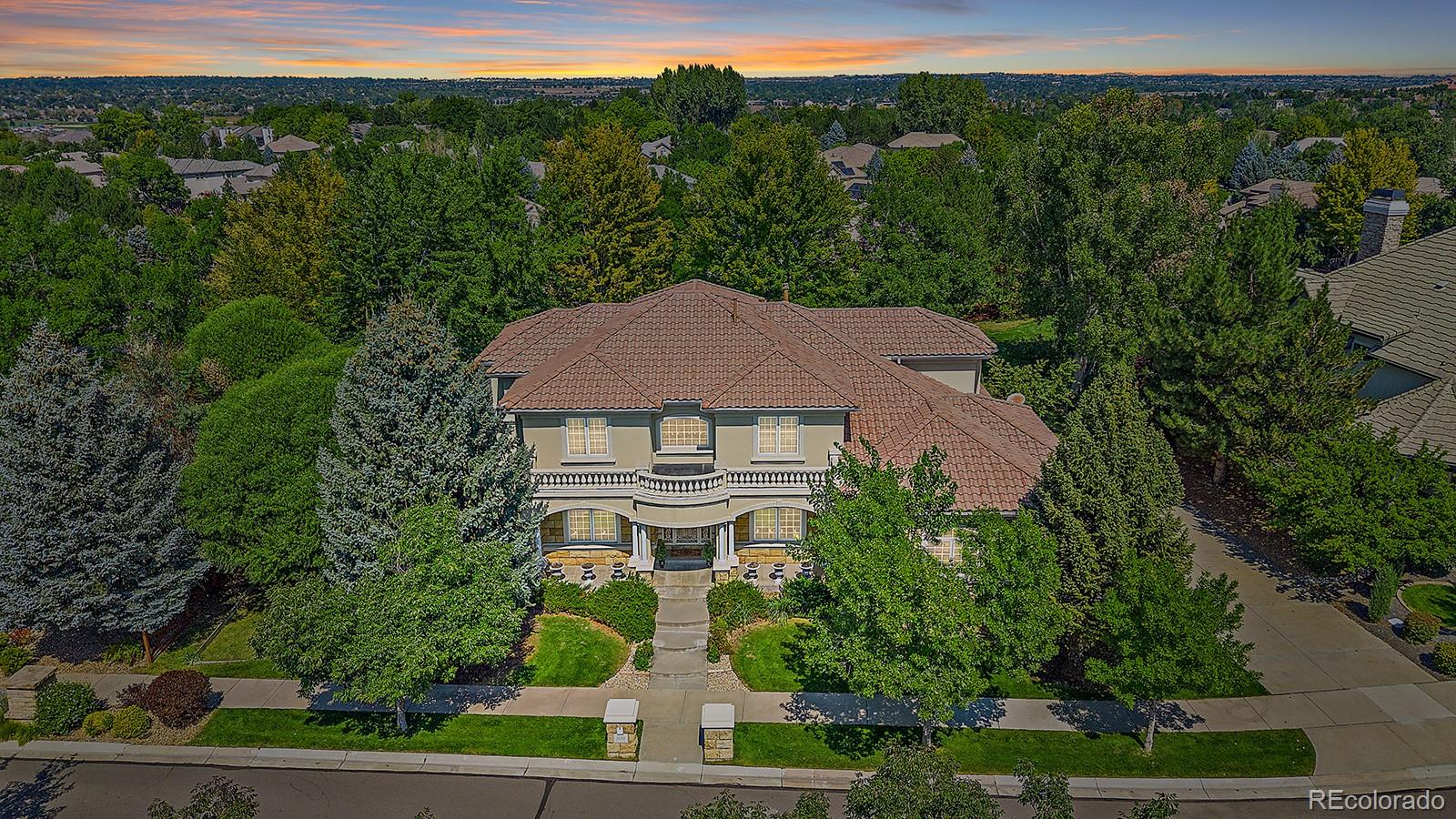 Awe inspiring, fully custom architectural masterpiece in coveted Ranch Reserve tucked behind the 15th tee on The Ranch Country Club Golf Course. Enjoy a private enclave with course views and a serene, tucked-away feel. This one owner, lovingly maintained home offers over 6800 square feet of space and offers an elite floor plan offering the perfect balance of luxury and practicality. The graciously vaulted entry features marble flooring and dramatic dual curved staircases to the open 2nd level landing. Main floor features a spacious study with floor to ceiling built in shelves + a formal dining area ready for candlelit holiday hosting. The two story great room features a wood paneled gas fireplace and adjoins a sunny breakfast nook accessible to the rear patio and Trex deck. Gourmet kitchen features ample cabinetry, slab countertops, stainless appliances, bar sink, large walk-in pantry and butlers serving area. The lavish main floor primary suite adds its own fireplace and a roomy six piece bath + supersized walk-in closet. A ¾ bath + laundry/utility area complete the main level amenities. Upstairs you’ll find three large bedrooms one with full en suite bath and one with jack and jill with each room having a dedicated sink area. You'll also find a large flex room perfect as a den, lounge area or additional bedroom option. The 2600 sq ft basement is partially finished and adds a 5th conforming bedroom with accompanying full bath + a considerably sized family room / rec area. Finish the additional footage to your taste or take advantage of ample extra storage. This home also offers the rare amenity of a walk up basement that leads directly to the oversized 3 car garage affording a great option for a home-based business, multi generational living, and more. Incredible opportunity to own an iconic home on one of the area’s most established, sought after blocks!