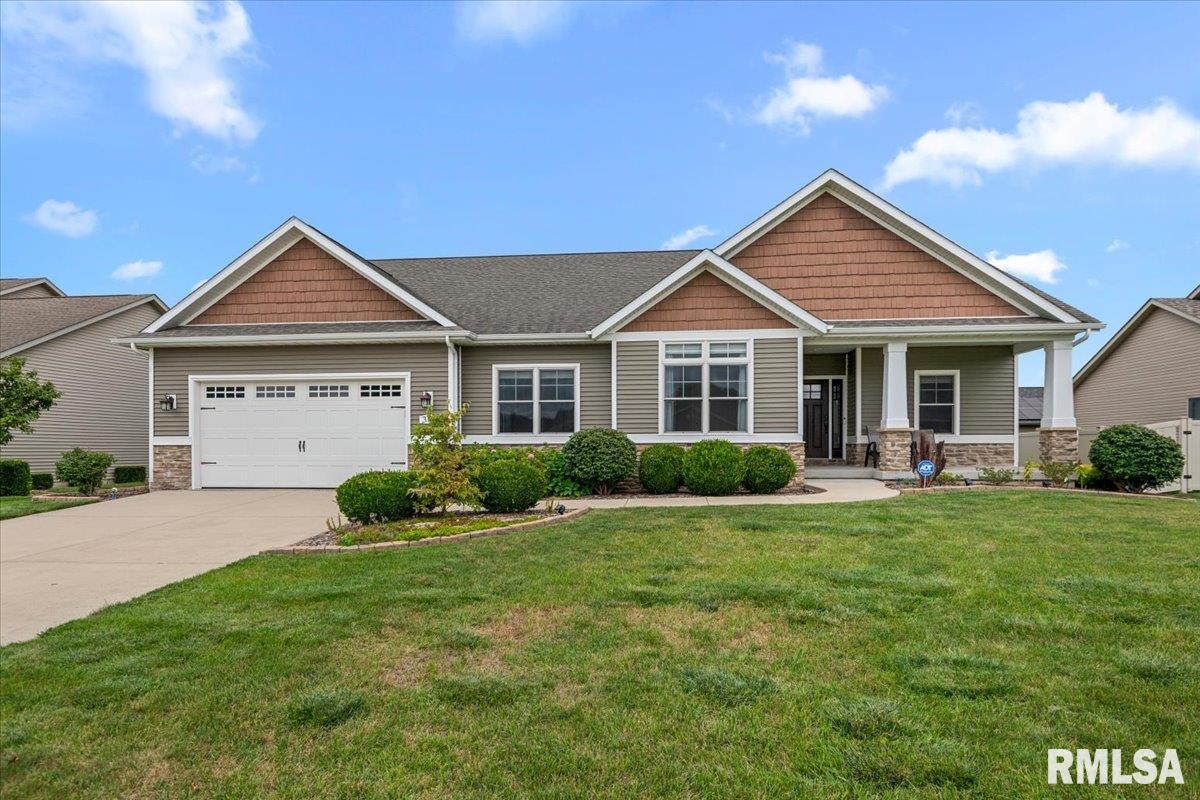 Stunning custom-built home overlooking the stocked pond in desirable Manor Hill II! This thoughtfully designed home offers an exceptional open floor plan w/beautiful finishes & an abundance of natural light. Hardwood floors flow from the foyer into the spacious great room, featuring a stacked stone fireplace & oversized windows overlooking the backyard. The gorgeous kitchen is equipped with quartz counters, an island, slate appliances, glass tile backsplash & pantry. The adjoining dining area offers a sliding door to the screened-in porch, creating the perfect space to enjoy the peaceful pond views. The spacious primary suite features a tray ceiling and luxurious ensuite bath with dual vanities, soaking tub, tiled shower with glass enclosure, and linen closet. The walk-in closet includes built-in organizers & connects directly to the laundry room, complete with granite sink top, closet & shoe storage. Drop zone with open lockers is located just inside the garage entry. Two additional bedrooms are located at the front of the home, while 4th bedroom features french doors & hardwood floors, making it ideal for a home office. The finished lower level provides incredible additional living space with a rec/family room, 2 bedrooms with egress windows, full bath, gym & a fantastic theatre room. The theatre room includes a kitchenette with full-size refrigerator, sink & seating. 3 car garage offers a 2-car tandem stall plus a dedicated workshop area. This custom home truly has it all.