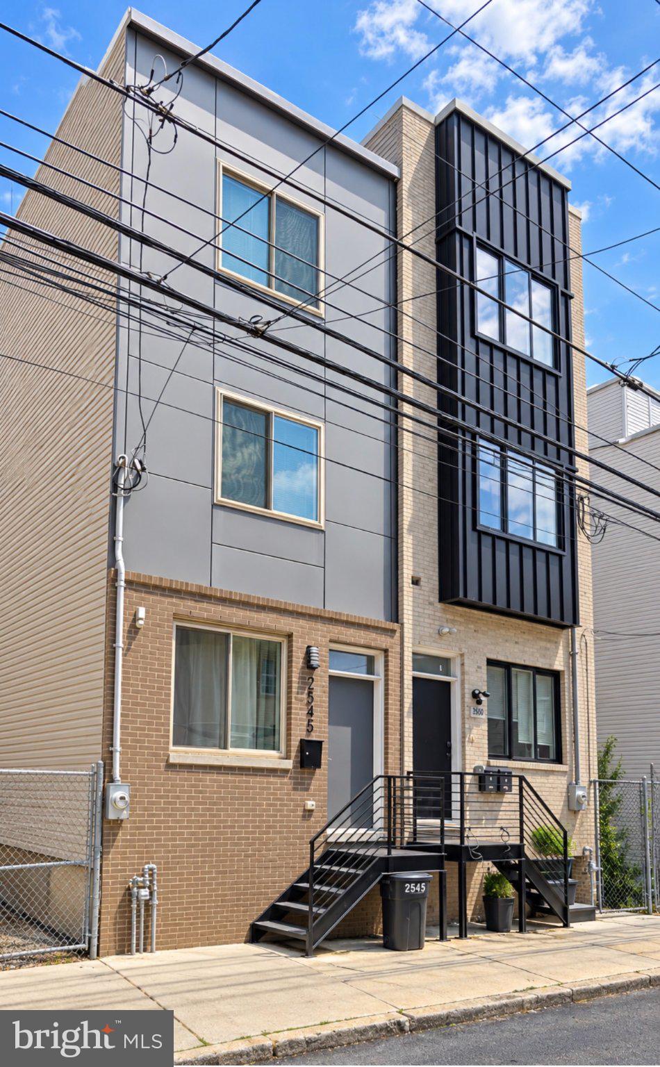 Welcome to 2545 N Howard Street, a modern three-story home built in 2021 offering 3 bedrooms, 3 full bathrooms, approximately 2,520 square feet of living space, a fully finished basement, private rear patio, and rooftop deck.The main level welcomes you with an open-concept living and dining area highlighted by a built-in electric fireplace with a striking floor-to-ceiling tile surround. The beautifully appointed kitchen features white shaker cabinetry, quartz countertops, a large center island, and ample space for dining and entertaining.The second floor offers two spacious bedrooms with generous closet space, a full bathroom, and a conveniently located laundry area. The third floor is dedicated to the private primary suite, complete with a walk-in closet and en-suite bathroom featuring a double vanity and oversized shower with dual shower heads. Just outside the primary bedroom, a wet bar with beverage refrigerator and additional storage provides added convenience and is perfectly positioned for rooftop entertaining.The fully finished basement adds even more versatility with a full bathroom and flexible bonus space ideal for a home office, gym, recreation room, guest area, or additional living space. Outdoors, enjoy a private fenced rear patio perfect for dining, relaxing, or entertaining, along with a rooftop deck offering additional outdoor living space and views of the surrounding city and skyline.Currently operated as a short-term rental, the property offers flexibility for an owner-occupant or investor and may be delivered furnished or cleared of personal property, with furnishings negotiable. Recent short-term rental performance and operating figures are available upon request.The property benefits from a City of Philadelphia 10-year new-construction real estate tax abatement, approved and implemented through May 31, 2031.Ideally situated in Norris Square with convenient access to neighboring Fishtown, the home is close to Norris Square Park, local playgrounds and community green spaces, as well as an exciting mix of cafés, restaurants, shopping, and entertainment throughout Norris Square and Fishtown. Nearby public transportation and major city routes provide convenient access to Center City and other popular Philadelphia neighborhoods.