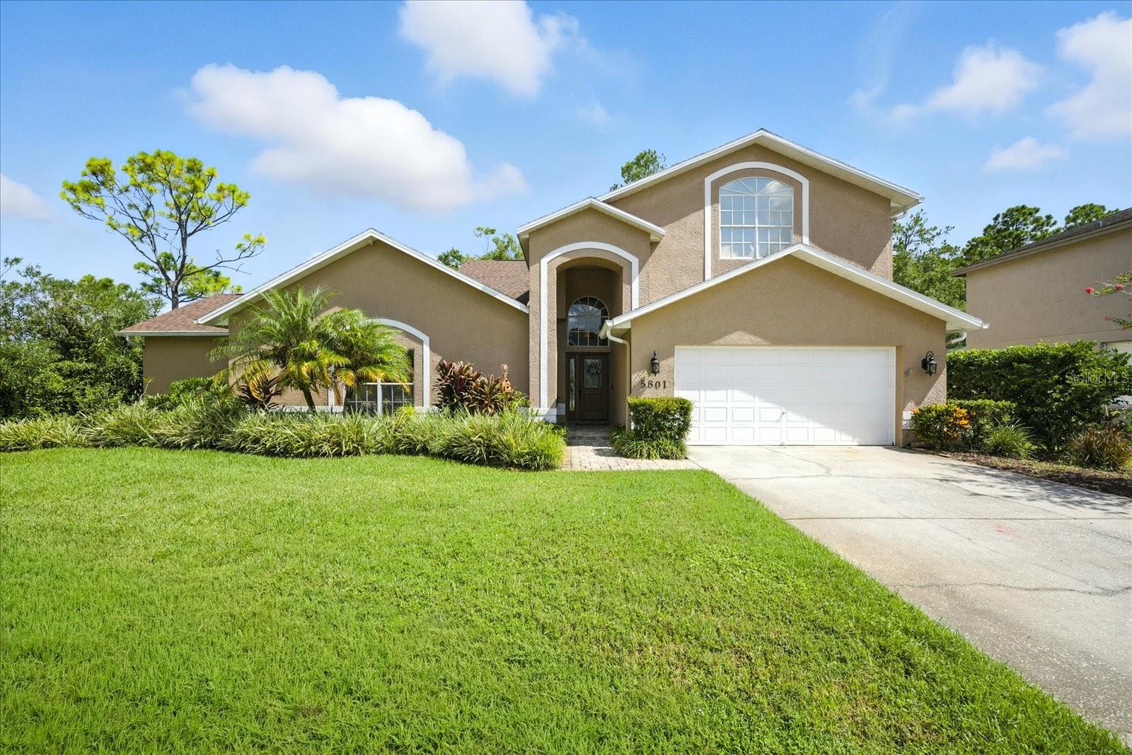 Spacious. Stylish. Spectacular. Welcome Home to 5801 Windermere Drive!  Tucked away in a private cul-de-sac of the highly sought-after gated community of Glenridge East, this 5-bedroom, 3.5-bath stunner offers the perfect blend of luxury, function, and Florida charm. With 3,186 square feet of beautifully designed living space, this home checks all the boxes—and then some.  Need room to roam? Enjoy two potential primary suites—one upstairs, one down—perfect for multi-generational living or ultra-flexible guest accommodations. Working from home or Movie nights? There’s a dedicated home office/media room for your hustle during the day and streaming your favorite shows at night.  Step outside and dive into paradise: your own screen-enclosed saltwater pool & spa, surrounded by brick pavers and backed by peaceful conservation views—no rear neighbors, just serenity. And with a brand-new shingle roof (June 2025) you can feel secure during storm season.  Inside, the kitchen is a showstopper, boasting GE Profile appliances, a pot filler, custom island, breakfast bar, coffee bar, and cabinet space for days. Entertain effortlessly with wide Pella sliding glass doors that bring the outdoors in.  Smart extras? Absolutely. Two tankless electric water heaters, keyless front door entry, ring doorbell and security cameras.  In the 2 car garage, you will find built-in cabinets and strong racks for extra storage.  Top-rated schools and a vibrant yet private neighborhood make this property a rare gem. Don’t miss your chance to live where comfort meets elegance in the heart of East Lake! Your dream home is waiting!