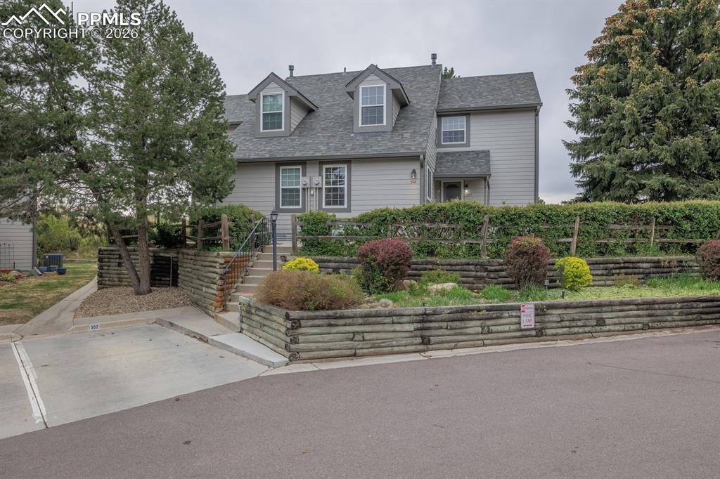 Gorgeous one owner end unit town home in Cobblestone backing to open space at the foot of Cheyenne Mountain.A path off the patio leads to the common green area & community pool. Custom built & lovingly maintained & updated through the years. Light & bright with a wonderful flowing floor plan. You enter through a covered porch into the main level with a bedroom & bath off the hall. The bath is updated with slab granite countertop & spa shower. In the hall are a coat closet & additional closet that serves as a pantry. Off the entry is a wonderful living & dining area with a floor to ceiling stone gas fireplace , a large custom picture window with views of Cheyenne mountain & open space. Custom shutters add an elegance to this space. The kitchen has a slab granite countertop & pass through to the dining area along with custom cabinets on the dining side for abundant storage. The kitchen is warm & inviting with custom cabinetry, under cabinet lighting & slab granite countertops. Walk out to a lovely patio and awning overhead for the summer months . Back inside & upstairs to a fabulous loft off the primary suite that has built in bookcases, ceiling fan & a view of Cheyenne mountain. The primary suite has an abundance of natural light with Cheyenne Mountain views, golf course & Country Club Lake. There is a window seat to enjoy the views.The primary bath has a spa shower & walk in cedar lined closet, new commode and views of course! Down the stairs into the basement family room with a built in desk/craft area. The laundry room is complete with a work area & built in shelving and an under dryer light. Conveniently located additional bedroom and bath make this basement a comfortable and inviting guest quarters. * New electrical panel & microwave* This lovely home is a one of a kind property, quiet, private end unit with nature at your back door.  District 12 schools close by. Walk to Broadmoor Valley Park . Close to military bases, shopping & downtown. Perfection awaits!