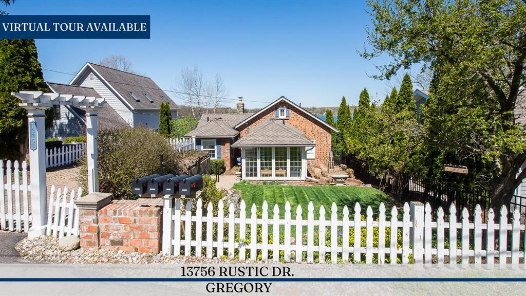 Welcome to 13756 Rustic Dr., an exceptional offering on highly coveted all-sports North Lake. This enchanting Cotswold-inspired cottage is rich in character and architectural charm, featuring a striking stone fireplace, rare clinker brick exterior, and a light-filled three-season entry with vaulted ceilings. Originally built in 1925, the home has been thoughtfully renovated and impeccably maintained, blending historic charm with modern comfort. Recent updates include a beautifully renovated first-floor bath and updated laundry area. Positioned to capture stunning sunset views, the property offers effortless indoor-outdoor living with a low-maintenance Trex deck and a winding path leading to your private beach and dock. Set on a rare double lot, the grounds feature a fenced yard, charming rose garden, manicured beds, and ample parking. A newly constructed three-car garage on the second lot includes a spacious loft, ideal for storage or future finished living space. A rare opportunity toown a timeless, character-rich lakefront retreat in a premier setting.Parcel #D-04-18-431-004 included in sale.