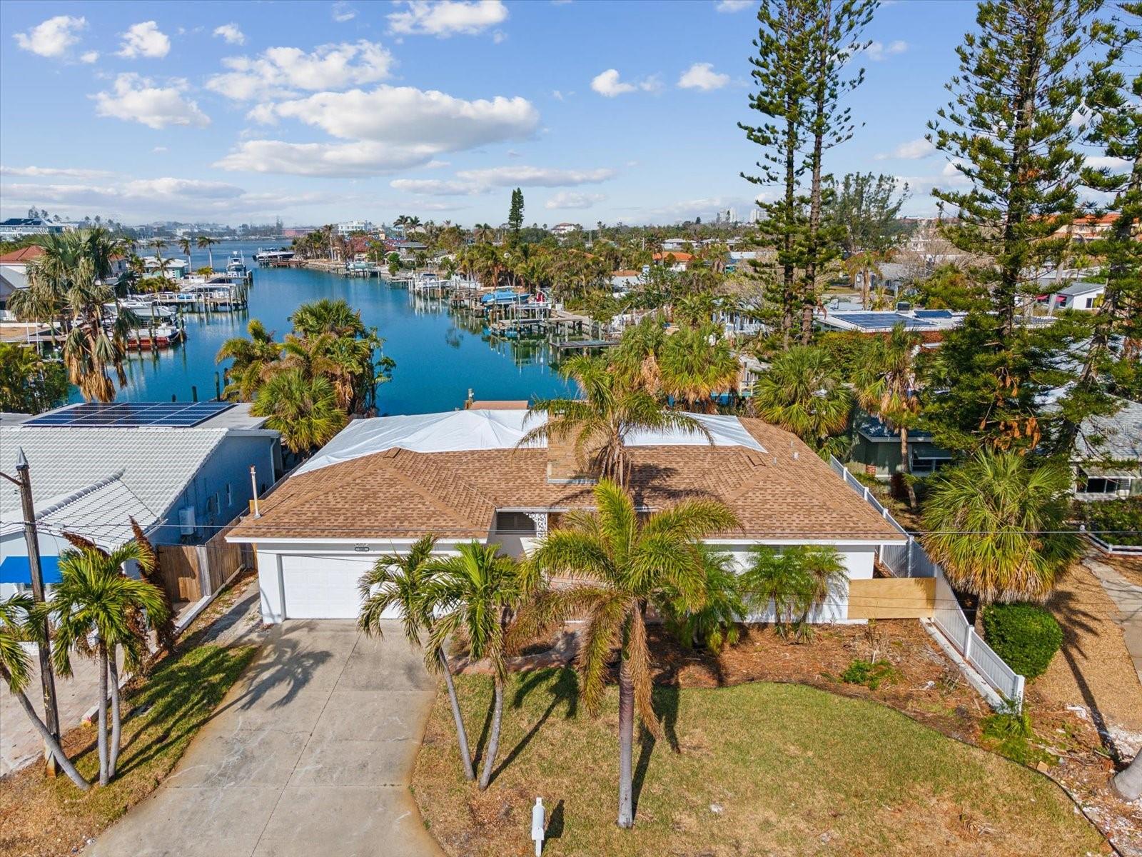 St. Pete Beach waterfront paradise! Come see this amazing view! This location is nestled at the end of a saltwater canal and is a boaters haven. From your dock you can easily reach the intercoastal and the Gulf of Mexico in under five minutes! This property was damaged during hurricane Helene but come renovate or rebuild in this highly sought-after area. Discover your dream coastal retreat! This stunning 2-bedroom, 2-bathroom waterfront home is perfectly situated just a short stroll from downtown St. Pete Beach and award-winning Upham Beach where you can enjoy breathtaking sunsets every evening. Inside, this home boasts an open and airy layout, perfect for entertaining or relaxing. The spacious living areas are filled with natural light, and the kitchen offers plenty of opportunities for entertainment. The primary suite features a private bath, while the second bedroom is perfect for guests or a home office. You'll love being walking distance to shopping, dining, and entertainment, making every day feel like a vacation. Whether you're looking for an active beach lifestyle or a serene waterfront escape, this home has it all! Don’t miss out on this rare opportunity to own a slice of paradise! Schedule your private showing today and start living the coastal dream.