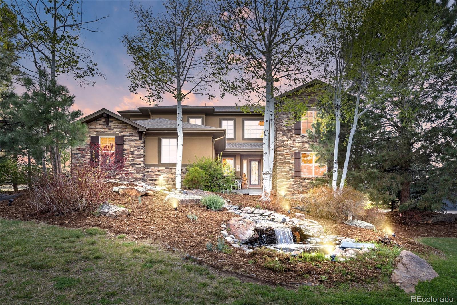 Custom 6 bed, 6 bath fully renovated mountain contemporary home. Nestled on a .57 acre lot backing to Pradera’s 14th fairway. Awe-inspiring golf course views with mature landscaping. The striking iron/glass front door opens to an airy open floor plan with soaring ceilings and Canadian hardwood floors, ideal for entertaining. The gourmet kitchen boasts honed quartz counters, large island with farmhouse sink, double ovens, gas range, walk-in pantry, and premium stainless steel appliances. The elegant formal dining room with custom mural is accessible via the butler’s pantry with glass-front cabinets & dual-zone beverage fridge. The great room’s wall of windows frames panoramic golf course views and includes a stone gas fireplace. Retreat to the upper mezzanine library with its brass chandelier, stone fireplace and elegant bookshelves with accent lighting, or the modern lower dedicated office with barn door entry. The sumptuous primary suite is a true sanctuary - golf course vistas through the expansive picture window, 5-piece bath with a deep soaking tub, massive walk-in shower, raised vanities, and dual walk-in closets. Two additional ensuite bedrooms, spacious loft, and a sizable laundry room complete this level. The basement has 1400 sq ft of entertaining space and lots of light: family room with lighted tray ceiling, 80” fireplace, Dolby Atmos system and wet bar with quartz counter, wine fridges, dishwasher and microwave. Also find a game room, 2 beds and 3/4 bath with custom tiled steam shower. The outdoor oasis beckons with a covered patio, stone fireplace and built-in grill, an extended concrete patio for dining, and a separate firepit lounge. Self-filling water features grace the front and backyards adding tranquility. An oversized 3-car garage allows ample storage. Prime Parker location moments from shopping, dining and recreation. Updated systems include new roof (2026), hot tub (2024), attic fan & A/C unit (2023). Unrivaled craftsmanship and luxury!