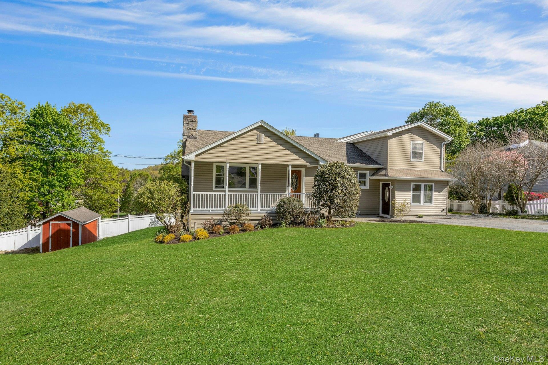 Bedford Hills Beauty! A front porch welcomes you to this light, bright, and move-in ready spacious home offering room for everyone with a flexible layout designed for today's lifestyle.  Featuring three full baths and a half bath, a dedicated home office or sitting room, and a beautifully finished lower level complete with a full bath, laundry, and utility area - perfect for guests, extended living or recreation.  The eat-in kitchen boasts a walk-in pantry, ideal for storage and convenience. There is a private patio, storage shed, and lots of parking. A super location close to the train, town, major highways, and schools, this home combines comfort, space, and accessibility in one exceptional offering. Enjoy town parks, pools, tennis, playgrounds, & all the Town of Bedford offers.