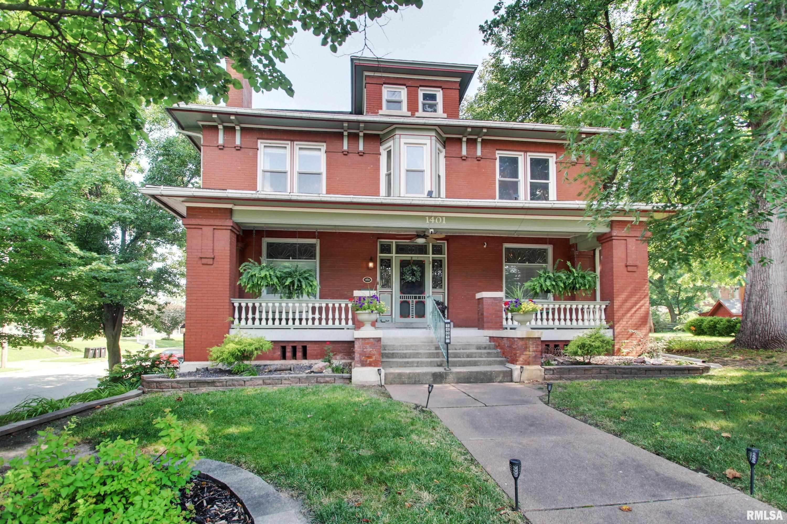 Fall in love with this stunning historic brick home built in 1912 where timeless elegance meets thoughtful modern updates like replacement windows throughout. Impeccably maintained and situated on a desirable corner lot, this remarkable residence showcases original woodwork, extraordinary craftsmanship, and the character that only a home of this era can offer. The heart of the home is the stunning custom kitchen, featuring granite countertops, stainless steel appliances, and a built-in wine refrigerator. The spacious main level also offers a grand living room with a wood burning fireplace, an elegant formal dining room, a primary suite, and a dedicated office with its own private exterior entrance; ideal for a home-based business. Upstairs you’ll find 3 generously sized bedrooms and exceptional closet space rare in historic homes and a floored attic provides even more storage. The basement offers flexibility with a separate exterior entrance, making it a great option for multi-generational living, guest quarters, or additional living space. Multiple finished rooms, a full bath with laundry, and abundant storage expand the home’s versatility and provide access to the 1 car drive in garage.  Step outside to enjoy your beautifully landscaped, privacy fenced backyard oasis featuring a 20’ x 22’ paved patio and storage shed. This extraordinary home perfectly blends historic charm with modern comfort, offering over a century of character, impeccable care, and endless possibilities.