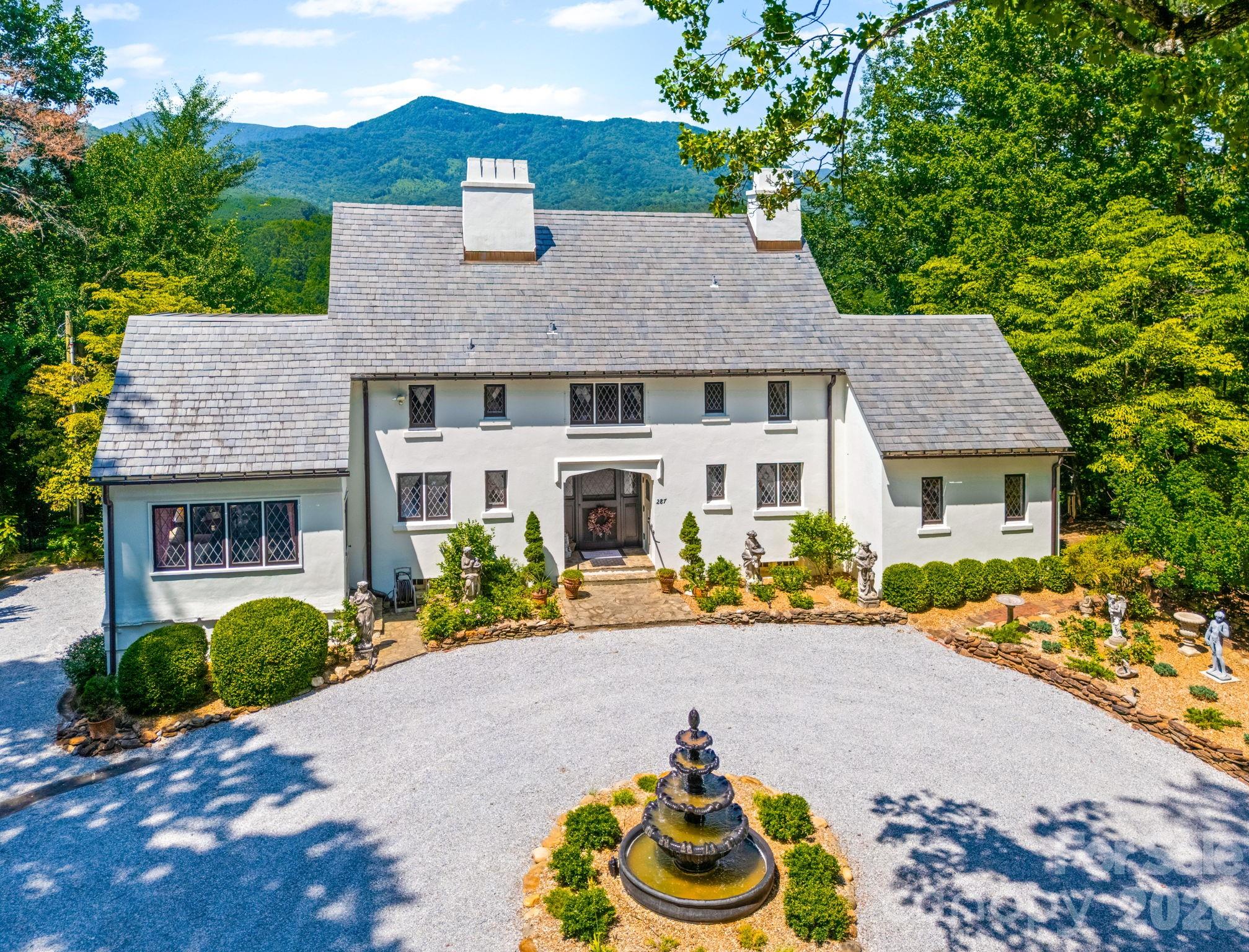 A Timeless English Cottage in the Carolina FoothillsPerched in a private setting with sweeping mountain views and unforgettable sunsets, this enchanting 1920s English cottage is a rare offering that blends historic character with refined modern comfort.From the moment you arrive, the home’s storybook presence is evident. Inside, warm and inviting interiors showcase original architectural details, handcrafted woodwork, and vintage accents that reflect the craftsmanship of a bygone era. Multiple fireplaces add ambiance throughout the home, creating intimate spaces designed for both everyday living and quiet retreat. The primary suite serves as a private sanctuary, featuring its own fireplace, en-suite bath, and an adjoining sitting room or office—ideal for reading, working, or simply enjoying the surrounding views. Throughout the home, thoughtful updates enhance comfort while preserving the integrity and charm of the original design. Outside, meticulously maintained gardens frame the cottage and create a peaceful connection to the landscape. A covered, screened patio extends the living space outdoors, offering a comfortable setting for year-round enjoyment and entertaining. Modern amenities include a dual-fuel HVAC system, whole-house generator, and security system, providing reliability and peace of mind without compromising the home’s historic appeal. Surrounded by the natural beauty of the Carolina foothills, the property offers easy access to hiking, horseback riding, and the shops, dining, and cultural attractions of the town of Tryon—making it an exceptional opportunity for those seeking character, privacy, and a memorable setting. Seller will provide a 1 year American Home Shield home warranty(Shield Complete)
