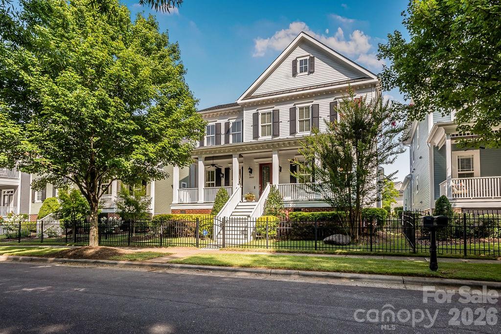 Welcome home to this beautifully designed home in one of Ballantyne's most desirable Charleston-style communities! A charming rocking chair front porch and fenced front yard create the perfect first impression. Inside, you'll find an open and airy floor plan filled with abundant natural light, gleaming hardwood floors throughout the main living areas, neutral paint, and custom built-ins surrounding the cozy gas fireplace.The chef's kitchen is truly the heart of the home, featuring a large center island, top-of-the-line appliances, ample cabinetry, and seamless flow into the dining and living spaces—ideal for both everyday living and entertaining.The spacious primary suite is conveniently located on the main level and offers dual walk-in closets and a luxurious en-suite bath. Two additional bedrooms are also on the main floor, providing flexibility for family or guests. Upstairs, you'll find a generous loft/bonus room, an additional en-suite bedroom, and an abundance of storage with tons of closets throughout the home.A versatile, heated flex room just off the rear-load two-car garage is perfect for a workshop, home office, fitness room, hobby space, or additional storage. Relax on the front porch while overlooking the beautifully landscaped common green space, offering a picturesque setting.Residents enjoy outstanding neighborhood amenities, including a community pool, all while being just minutes from Ballantyne's shopping, dining, entertainment, and major commuter routes. This move-in ready home combines thoughtful design, exceptional storage, and an unbeatable location—don't miss your opportunity to make it yours!