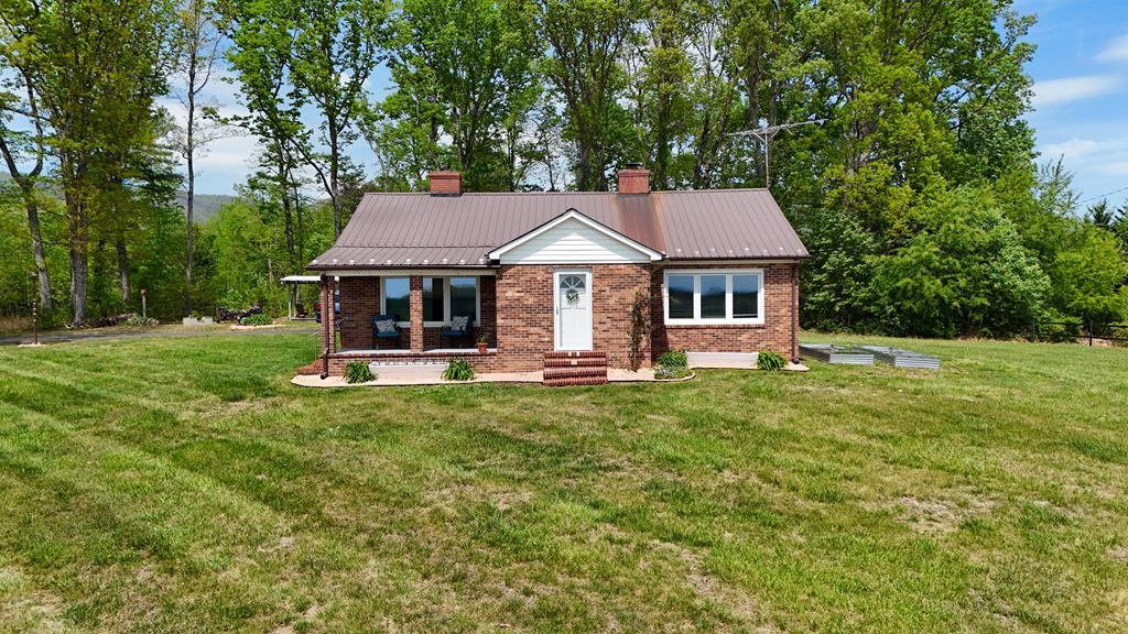 60 Edwin Lane, Cana, VA offers a country setting and brick home for your personal residence or weekend site for relaxation. Charming home with 2 bedrooms, cozy living area with fireplace, kitchen and laundry, 1 bath. One bedroom has a fireplace. Covered front porch looks across Sandy Ridge to the neighbor's farm with pond. Out building for additional storage. Grass and wooded acreage of 2.3 +-acres.