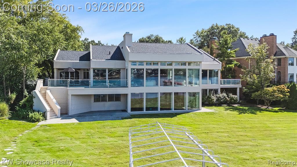 A RARE FIND!. LUXURIOUS LAKEFRONT RANCH WITH 98 FT OF SANDY SHORELINE ON PRIVATE, ALL SPORTS LOWER STRAITS LAKE! BEAUTIFUL BRICK CONTEMPORARY IS LOCATED AMONG CUSTOM BUILT HOMES IN HIGHLY SOUGHT AFTER PINE COVE VILLAS OFFERING A SUB BEACH, PARK, TENNIS & PICKLEBALL COURTS. CUSTOM BUILT HOME features an open concept, 6,551 SF of Living Space, a beautifully finished lower level walk-out, 1st floor and LL Laundry Rooms, elevated terrace with glass rail, large patio and oversized 3 car Garage. Spacious Foyer features a soaring ceiling, walk-in closet and views into multiple rooms. From the Foyer, rich hardwood flooring flows into the Dining Area featuring a built-in buffet. The Large Great Room features a 12’ ceiling, a wet bar, gas fireplace with granite surround and door-wall leading to the raised terrace.  A full wall of windows extending from the floor to the ceiling provides stunning lake views! The Library includes built-in display/storage and Powder Room features a granite vanity and hardwood floor. The large Kitchen/Nook are furnished with an abundance of custom cabinetry with under/over lighting, granite counters, premium KitchenAid appliances, Island with snack-bar counter, built-in desk, hardwood flooring and door-wall to the terrace. The Sun Room features a 12' door-wall leading to the patio. The Owner's Suite features large windows facing the lake, door-wall to a private deck and built-in storage/display. The Ensuite is furnished with a Euroglass enclosed shower w/marble surround, jet tub, vanity w/marble counter and marble floor. The private retreat includes His & Her walk-in closets w/built-in organizers & Dressing Area w/make up vanity. The LL includes a huge Family/Rec Room featuring a wall of windows facing the lake, a door-wall to the patio and a wet Bar/Kitchenette.  Bedroom Suite 2 includes a walk-in closet and full Bath, Bedrooms 3 & 4 feature W.I.Cs, Hall Bath w/step-in shower and Art/Flex Room. Mud Hall with closet is located at the Garage Entry.