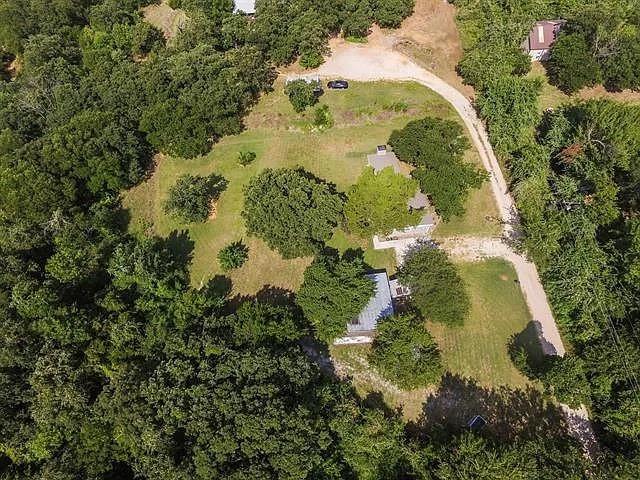 This one-acre homesite is a hidden gem, a rare slice of West Flower Mound, where the land itself steals the show. Tucked near scenic Lake Grapevine, this one-of-a-kind property backs to U.S. Army Corps of Engineers land, offering a natural buffer, some wildlife, and easy access to miles of shoreline trails and outdoor recreation. The existing “AS IS” 3-bedroom, 1-bath house adds instant livability or rental potential while you design your dream home, guest compound, or luxury retreat nestled among custom estates. With a coveted location close to exclusive Sunset Point at Twin Coves and elegant Wright Estates, you’re surrounded by high-end neighborhoods, parks, and lake amenities that support strong long-term land value. Whether you’re a builder, investor, or future homeowner looking for privacy, trees, and room to create, this is a land-first, lifestyle-driven opportunity that seldom hits the market.