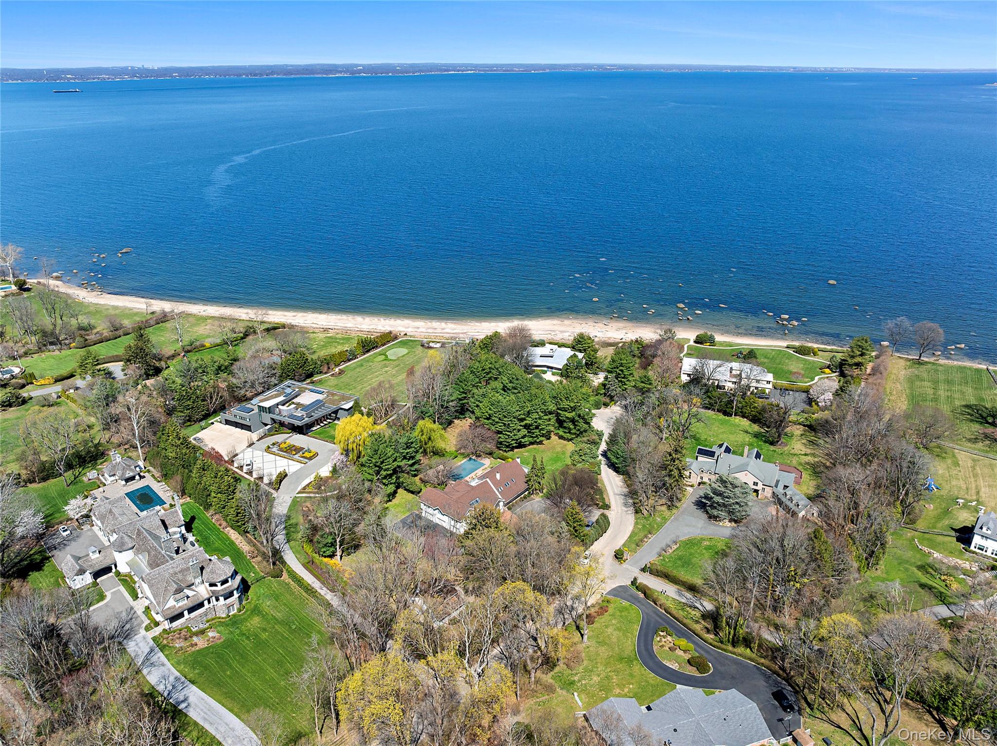 92 Old House Lane is a rare chance to own an estate in Sands Point with direct beach access, designed for entertaining and meant to be enjoyed for generations. Set on two private acres with an in-ground pool and tennis court, perhaps the best part of all is the gorgeous sandy beach accessed through a private path from the backyard. Tucked away in a desirable enclave on the east coast of the Village, the main house features clean, sun-drenched lines with large living and entertaining spaces. There are also six bedrooms and four full bathrooms. A separate two-bedroom guest cottage on the property adds flexibility for hosting or extended stays.Perfectly positioned just 40 minutes from Manhattan and a couple of miles from the trains, major roadways and the vibrant Port Washington downtown, it offers the best of both worlds: complete seclusion with effortless accessibility. Whether as a serene escape or a year-round residence, this is a place to create something enduring that one cannot replicate anywhere else.