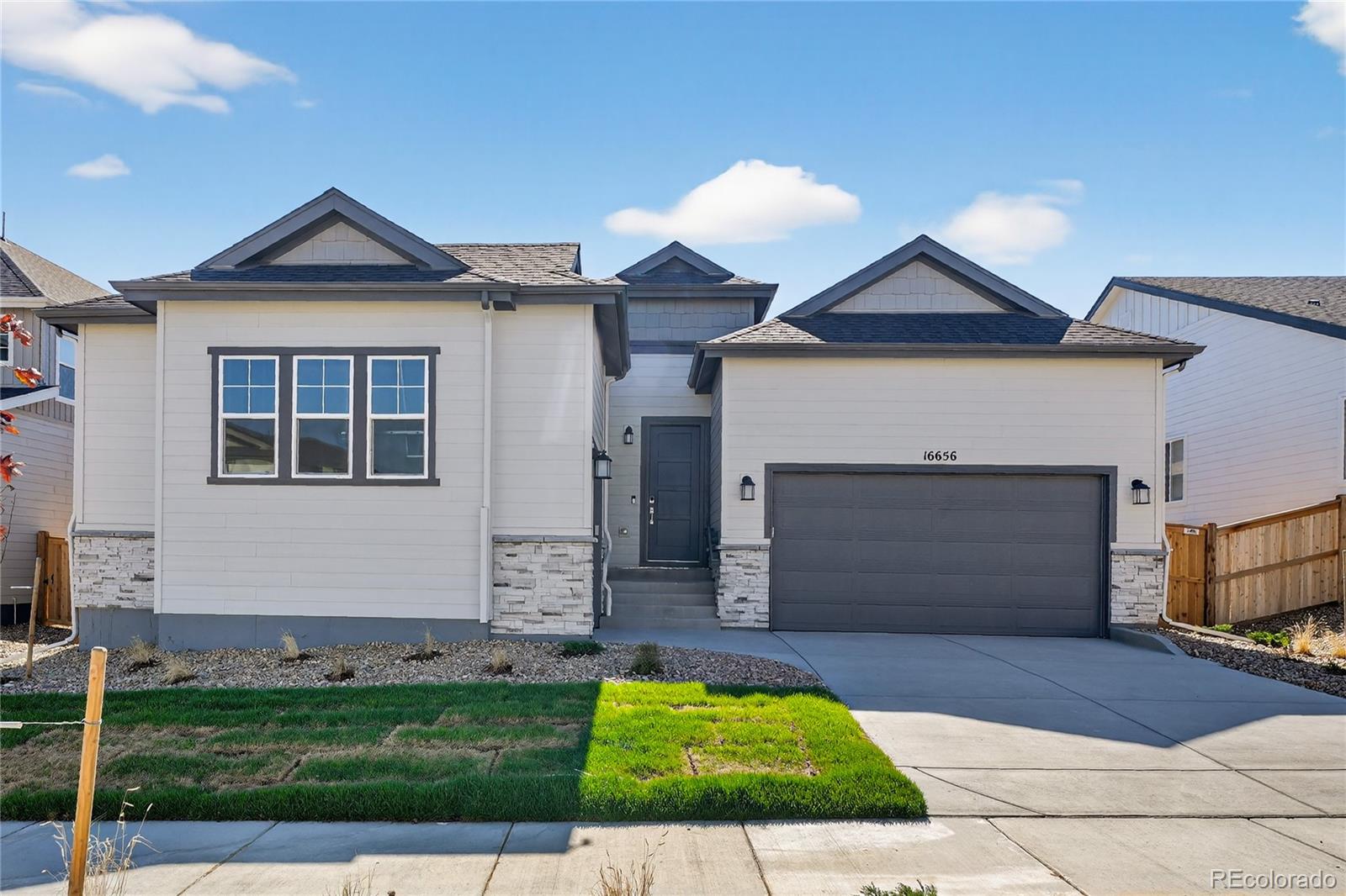 What's Special: 3-Car Garage | White Cabinets | Convenient 1st Floor Living.New Construction - Ready Now! Built by America's Most Trusted Homebuilder. Welcome to the Snowmass at 16656 W 93rd Place in Trailstone, a thoughtfully designed single-story home offering spacious comfort and natural light throughout. From the entry, two bedrooms and a full bathroom create a welcoming front wing, while the breathtaking kitchen with abundant cabinetry, a walk-in pantry, and a large island flows into the dining room and great room for easy entertaining. A cozy hearth room with a two-sided fireplace adds warmth, and the secluded primary suite provides a serene retreat with a freestanding tub, walk-in shower, dual vanities, and a generous closet. A flexible bonus room and an unfinished basement offer space for hobbies or future expansion. Located in Trailstone, a vibrant community just 15 miles from Boulder, you’ll enjoy incredible views of Downtown Denver, the Rocky Mountains, and Standley Lake, along with planned amenities like an outdoor pool and pickleball courts for an active, connected lifestyle. Additional highlights include: dual-sided fireplace, patio, free-standing tub at primary bath, extended hard surface flooring throughout, rough in plumbing for future basement bathroom and gas line rough in for future outdoor kitchen.
