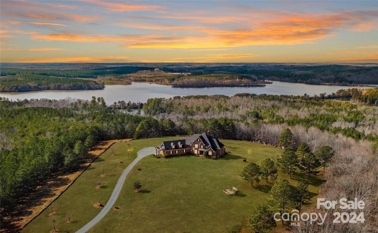Welcome to Tuckertown Estate - an entirely custom-built 9000sqft+ home overlooking the National Forest w/ a backdrop of Tuckertown Reservoir. Sitting on 412+acres, bring your UTV's and explore the endless paths & all this property has to offer! Estate features 10-12ft ceilings throughout, expansive windows & daily gorgeous sunset views! Enjoy main floor w/ beautiful chefs kitchen & designer SS appliances, a heated/cooled epoxy coated 2 car garage, mud room, sitting room & 2story great room. Thoughtfully designed primary BR suite has large thermostatic gas fireplace, 2 generous custom walk-in closets, primary bath suite w/ jetted tub & shower. Upstairs - 2BR/2BA, large bonus room w/ private balcony & additional sitting area/loft. A true entertainer will love the basement feat. addtl. full kitchen/bar, billiard area, 2BR/2BA, workout room & more! The home offers an abundance of entertainment areas and multi-use spaces, idyllic for your private retreat on boundless acreage! 3600sft shop!