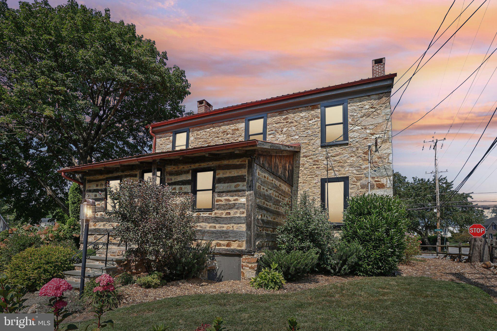 Dreaming of a true farmhouse, with land, but near all the places you love to shop and dine? Well, welcome home to 100 Milford Road, also known as the Conrad Keely House dating to the late 1790s.   Nestled on a picturesque property, this charming 3-bedroom, 2-1/2 bath farmhouse offers the perfect blend of rustic charm and modern convenience. Surrounded by scenic landscapes, this property is ideal for those seeking a peaceful retreat while staying close to local amenities.  Step inside to discover a cozy yet spacious interior with original hardwood floors, numerous built-ins and extra deep windows, allowing for an abundance of natural light. The kitchen, with vaulted beamed ceiling, boasts updated appliances, beautiful soapstone counter and farmhouse sink and a large area for dining.  The powder has been recently updated and adjoining living room warmed by a gas fireplace flows effortlessly into the family room which is perfect for family gatherings or entertaining. The spacious main level of this home also boasts a large flex room, currently effortlessly functioning as a home office and an impressive dining room offering yet another fireplace, perfect for adding additional warmth to your holiday traditions. Three generously-sized bedrooms offer comfort and privacy, with the primary bedroom featuring an en-suite bath and breathtaking views of the surrounding grounds. The additional bedrooms share a full bathroom, both beautifully updated with modern fixtures while retaining the home’s classic appeal. Outdoors, the 2 large barns provide ample space for entertaining and dining al fresco with additional options for storage, a workshops, craft area, and so much more.  The charming spring house adds a touch of historic charm to the property. The well-maintained grounds offer opportunities for gardening, outdoor recreation, gathering by the firepit or simply soaking in the beauty of nature. New AC system installed June 2024 and Pella windows and door September 2022. This property offers endless possibilities. Enjoy country living at its finest with expansive, tranquil grounds and a serene home all within reach of local conveniences.  Don’t miss your chance to own this one-of-a-kind farmhouse!