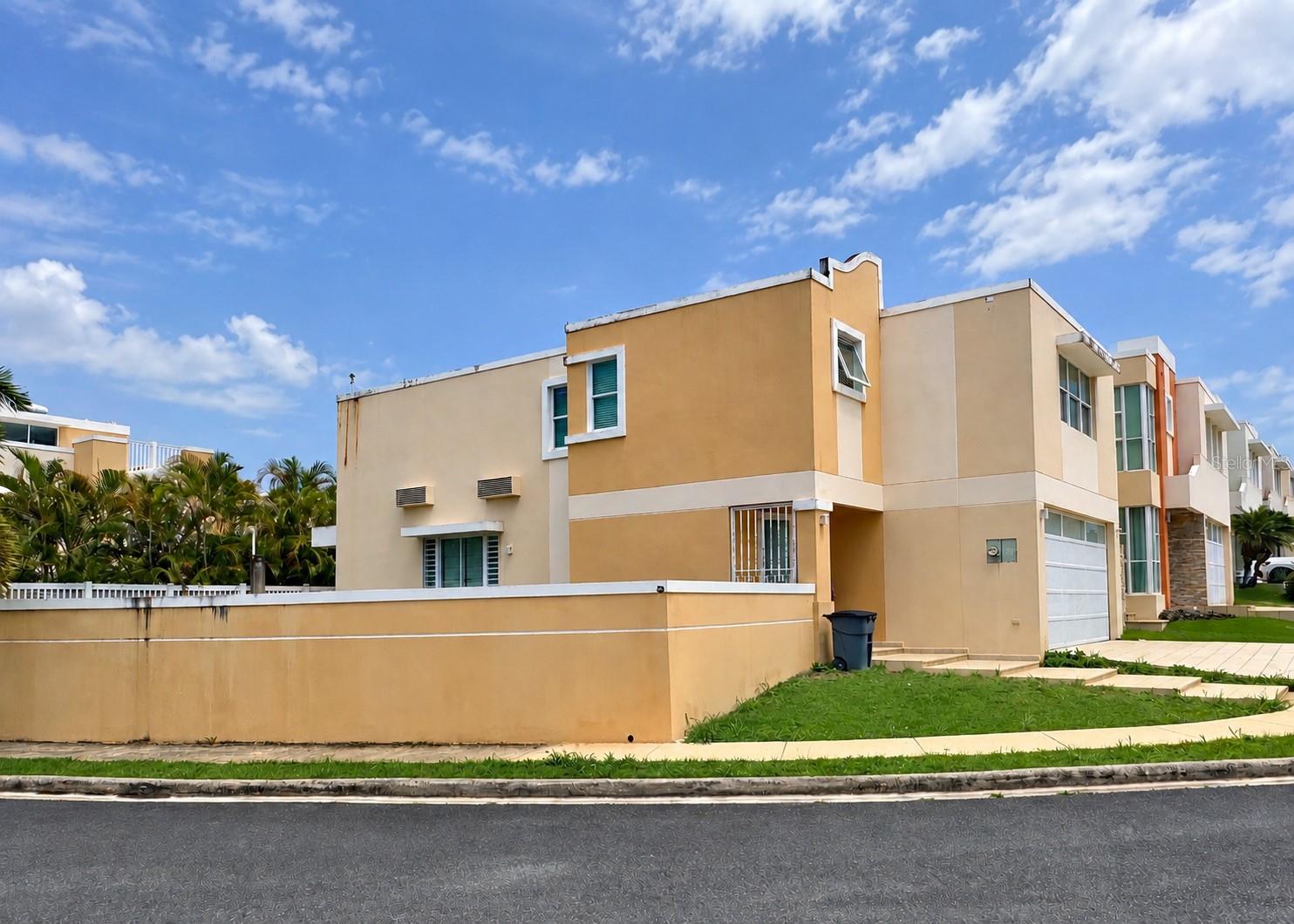 Short Sale. Excellent opportunity to own a corner property in Mirabella Village & Club, Bayamón, a guard-gated community with 24/7 security and resort-style amenities. Located just near the common areas, the community offers adult and children’s swimming pools, jacuzzi, tennis court, gym, children’s park, half basketball court, and an enclosed activities hall. The residence, with some 2,256 sf structure in a 356 sm lots, features a family room, Principal Suite, Junior Principal Suite, and a spacious backyard with excellent potential for a terrace and private swimming pool. Immeddiate access to PR-29 (West Main Ave.) and located 2-4 miles from PR-5, PR-2, PR-22 and Plaza del Sol. This property is being offered as a Short Sale with a potentially expedited approval process. It is sold AS IS and requires some repairs that can be completed prior to a financed closing. All offers are subject to lender approval and might not be subject to appraisal. No interior photos are available for public distribution.