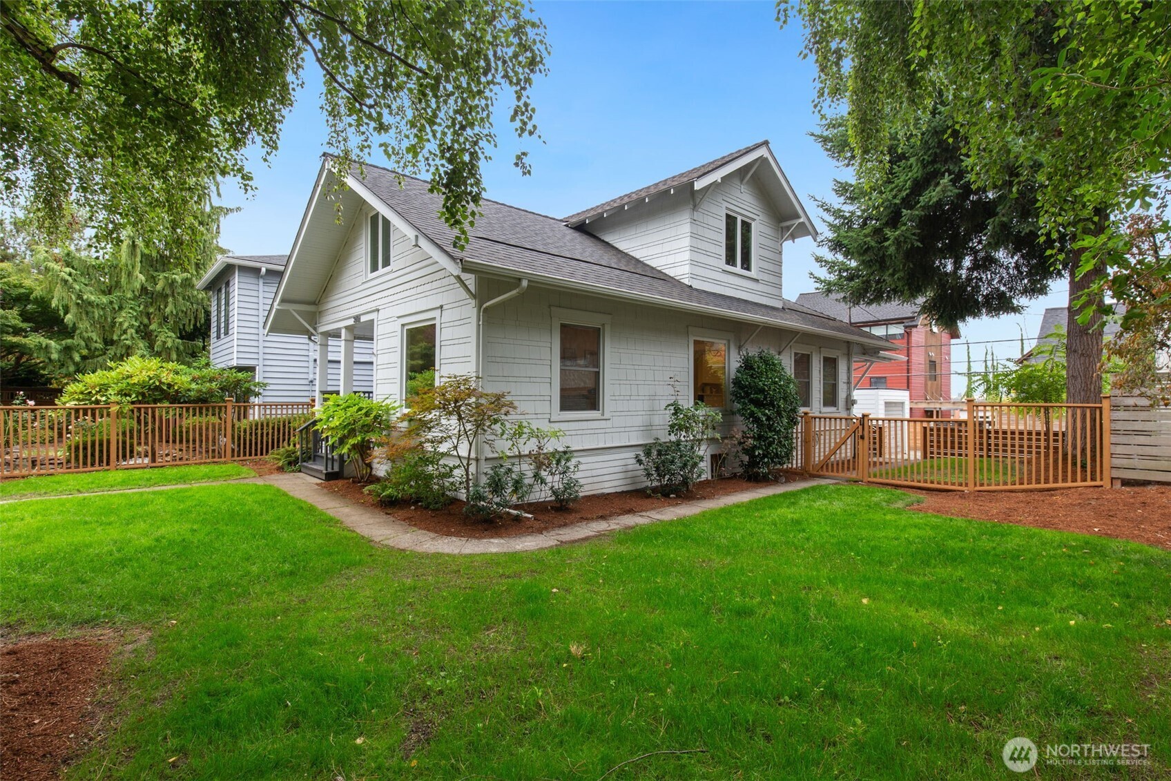 Ideally located in the heart of Green Lake, this classic Seattle craftsman pairs timeless original charm with thoughtful updates for modern living. Set on a large lot, this inviting home features a cozy front porch that welcomes you into spacious living & dining rooms with built-ins & soaring ceilings. Oversized windows overlook the large picturesque yard - a rare find in this location. The open, light-filled kitchen features charming cabinetry, a dining area with plenty of room to sit around the table & easy access to the fully-fenced yard. Two bedrooms, a full bath with clawfoot tub, and office/den complete the main floor. Upstairs are two additional bedrooms, a 3/4 bath & walk-in closet. Two off-street parking spaces are located in the rear, accessible from the alley. A one-car detached garage offers additional parking, space for a workshop, & bike storage. The unfinished basement also offers excellent storage. Many system updates include electrical & a high-efficiency boiler (for radiant heat), in addition to brand-new flooring, fresh paint, & landscaping. Close to plenty of transit options & I-5, along with a Bike Score of 90/100 make for an easy commute. Located on a quiet street, and just blocks to Green Lake, Community & Aquatic Center, library, PCC, coffee shops & restaurants, this home offers the very best of Green Lake living! Seller pre-inspection & sewer scope completed.