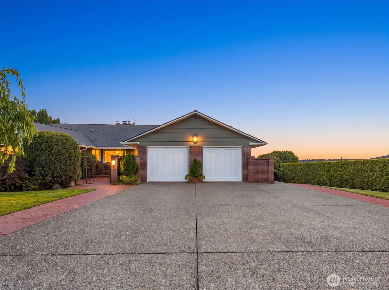 First time on the market since 1987! Set on Tacoma’s desirable West Slope, this 5-bedroom, 3,470 sq. ft. home pairs sweeping views with a beautifully established setting and the ease of main floor living. Western exposure captures incredible sunsets over the bay, Olympic Mountains and Narrows Bridge. An inviting entry opens to a beautifully laid out interior with original hardwood floors and abundant natural light. Distinct living, dining and gathering spaces, including a wood-paneled den with fireplace and bar, give the home a timeless feel, while large windows frame the incredible view. A spacious primary suite with walk-in closet and heated bathroom floors, along with a second bedroom, complete the thoughtful main floor layout.    Outside, mature landscaping, manicured hedges, expansive lawns and a large lavender garden create a private and beautifully established setting. The covered back deck with outdoor fireplace is made for dining, entertaining and sunset evenings, while a lower patio and additional seating areas offer even more ways to enjoy the outdoors.    Meticulously cared for and thoughtfully updated over the years, this home reflects true pride of ownership. Improvements include a new sewer line, all-new plumbing, new furnace, solar panels and updates to all other major systems, with a pre-inspection report available. A two-car garage, attic storage, and easy access to the waterfront, shopping, dining and commuter routes complete this special West Tacoma home.