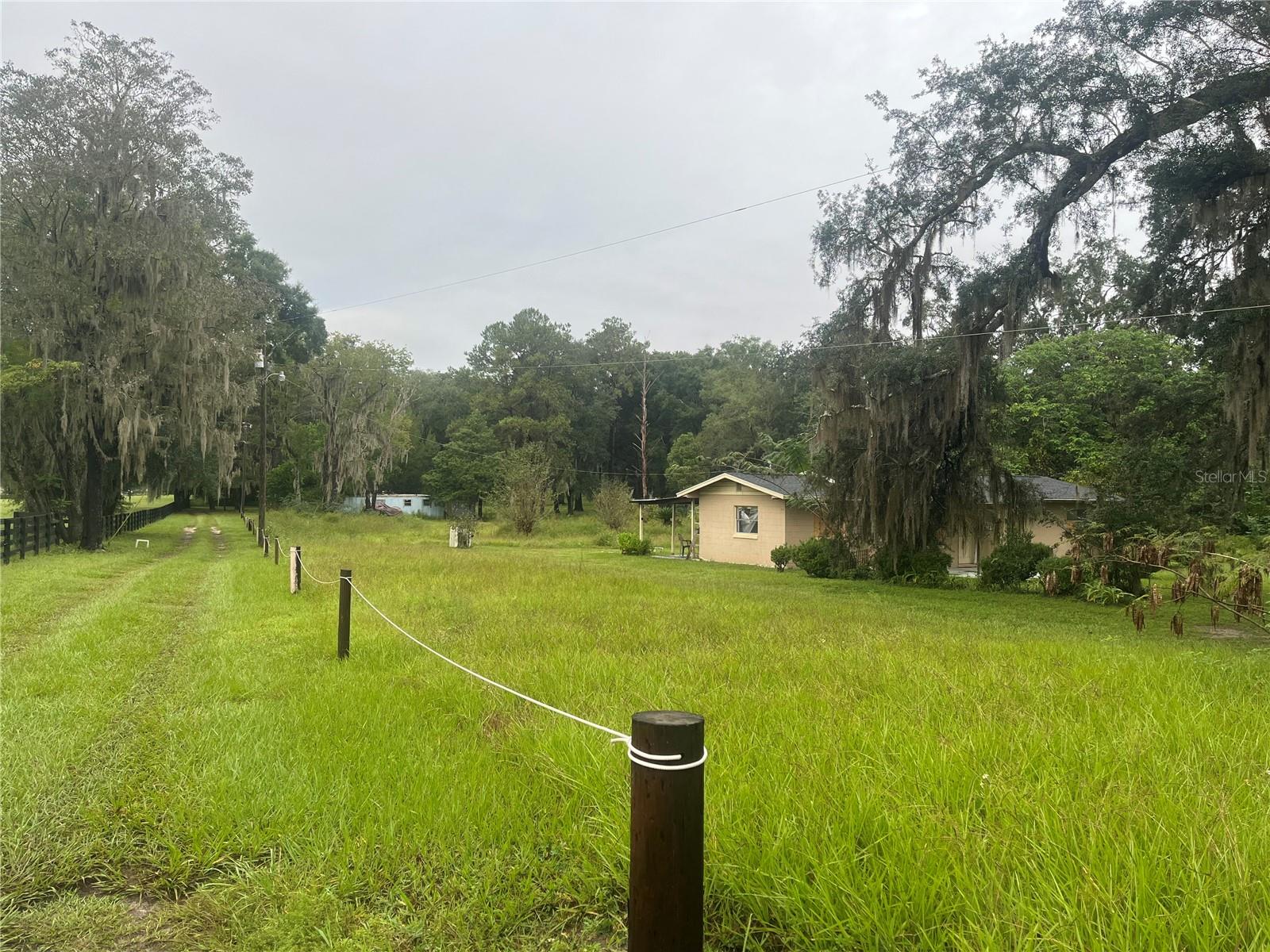 A LITTLE BIT OF COUNTRY, A WHOLE LOT OF POTENTIAL! NO HOA! NOT IN A FLOOD ZONE! SELLER OFFERING FINANCING. $50,000 DOWN. TERMS APPLY- Discover 1.89 acres of A-1 zoned land tucked away just off Hwy 475 in Ocala, surrounded by larger acreage properties and endless possibilities! This unique property features a 4-bedroom, 1-bath concrete block home with a NEWER 2022 ROOF, an older mobile home currently on site, and THREE separate 911 addresses! Ideally situated approximately 12 miles from the World Equestrian Center and just 5 miles from the Florida Horse Park, the location is hard to beat! Whether you’re dreaming of a charming mini farm, a peaceful country retreat, or simply a little more room to spread out, this property is ready for someone with vision to make it their own. BRING YOUR IDEAS, YOUR ANIMALS, AND YOUR IMAGINATION! Opportunities like this don’t come along every day. Schedule your private showing today!
