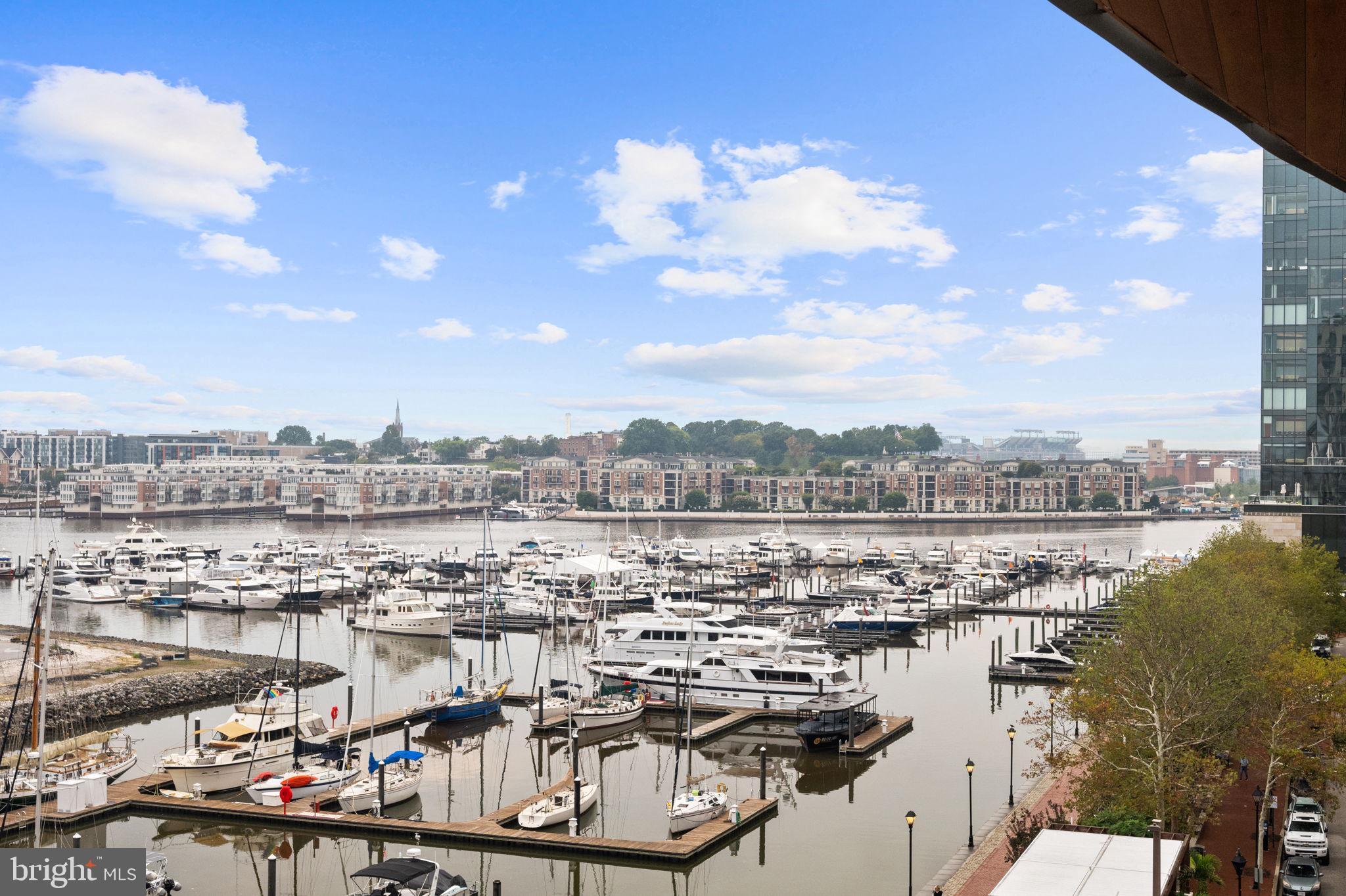 Experience luxury waterfront living at Liberty Harbor East! This stunning 2-bedroom, 2-bath residence offers over 1,500 square feet of sophisticated like-new space. With breathtaking panoramic views of the city and water, this is one of the few units in the Liberty to enjoy a private balcony off of the main living area. The unit is ideally situated in the building to maximize harbor views while providing a calm and quiet retreat in the heart of Harbor East. This smart home features soaring ceilings, oversized windows, wide plank oak floors, and a custom mirrored media wall with TV and gas fireplace. The spacious chef’s kitchen boasts Italkraft cabinetry, Thermador appliances, and a waterfall marble island- perfect for any home chef! The spacious primary suite offers floor-to-ceiling windows, a custom California Closet, and a spa-like en-suite bath with Carrara marble, Kallista & Kohler fixtures, and dual vanity. A split layout ensures privacy within the unit. The second bedroom is generously sized with a walk-in closet and an additional hall full bathroom. One garage space is included in the purchase. Residents enjoy unmatched amenities at the Liberty including a rooftop infinity pool, state of the art fitness center, pet park, concierge lounge, private dining, and direct access to Whole Foods. Steps from top dining, shopping, and waterfront paths—this is the ultimate downtown lifestyle.