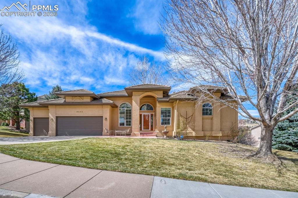 Picture standing on the deck or looking out walls of windows at breathtaking views of Pikes Peak, the front range and Garden of the Gods.  Welcome to complete main level living in the desirable St. Andrews neighborhood.  Two blocks from the Colorado Springs Country Club and directly across from 700 plus acres of Palmer Parks' scenic acres of hiking and biking trails.  Attractive stucco exterior with a tiled roof and a large three car garage.  Beautifully landscaped large private lot.  Sit on the front yard partially covered patio with a fountain or the large backyard deck with all the views.  As you enter the house you are welcomed with a gracious tiled foyer, lots of natural light, vaulted ceilings and large columns that create symmetry and defined spaces.  Beautiful dining room, living room with a wall of windows, main level office or could be used as a 5th bedroom.  Enter the gourmet kitchen with hardwood flooring, corian countertops, kitchen aid cooktop, microwave and oven.  Sit at the large breakfast island (bar stools included) or the spacious breakfast nook with a three sided gas log fireplace.  Family room opens to the kitchen and you can also enjoy the three sided gas log fireplace.  Wall of windows and walks out to the deck.  Second main level bedroom and full bath.  Enjoy the views and walk out to the deck from the spacious primary main level bedroom featuring hardwood flooring, two walk-in closets and a large 5-piece bath.  Curved hardwood stairs lead to the walkout basement.  The basement features a family room with a walk out to the backyard, two large bedrooms and a full bath with granite counters.  Large storage room. Other features include central air, finished garage, and a wrought iron partially fenced backyard.  Located minutes from shopping, dining, hiking and biking.   Join the Country Club and enjoy the swimming pool, a round of golf or tennis.  Easy access to I-25.  Don't miss this opportunity to own a beautiful home with spectacular views.