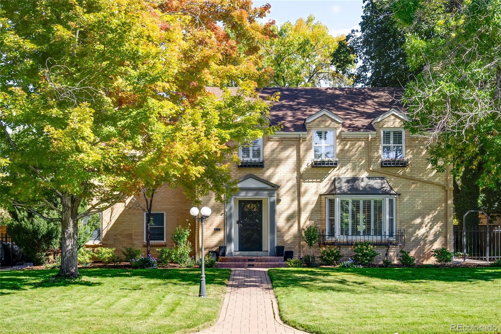 A masterful blend of timeless character and modern luxury defines this fully remodeled Park Hill residence, where natural light and refined design flow through every space. The open main floor welcomes residents with gleaming wood floors and a sunny living room with a bay window, classic shutters and fireplace. An elegant dining area with south-facing windows and French doors opens to the back patio. The chef’s kitchen impresses with a Wolf range, quartz waterfall island, farmhouse sink and custom cabinetry. Upstairs, a remodeled primary suite features a wall of closets and a stunning five-piece bath with a freestanding tub. A second-floor living room with windows on three sides and a fireplace adds warmth and flexibility. The professionally remodeled backyard offers an electric gate, a paver patio and mature trees, ideal for outdoor entertaining. With a finished basement, ample storage and an attached two-car garage, this home captures the essence of modern Park Hill living.