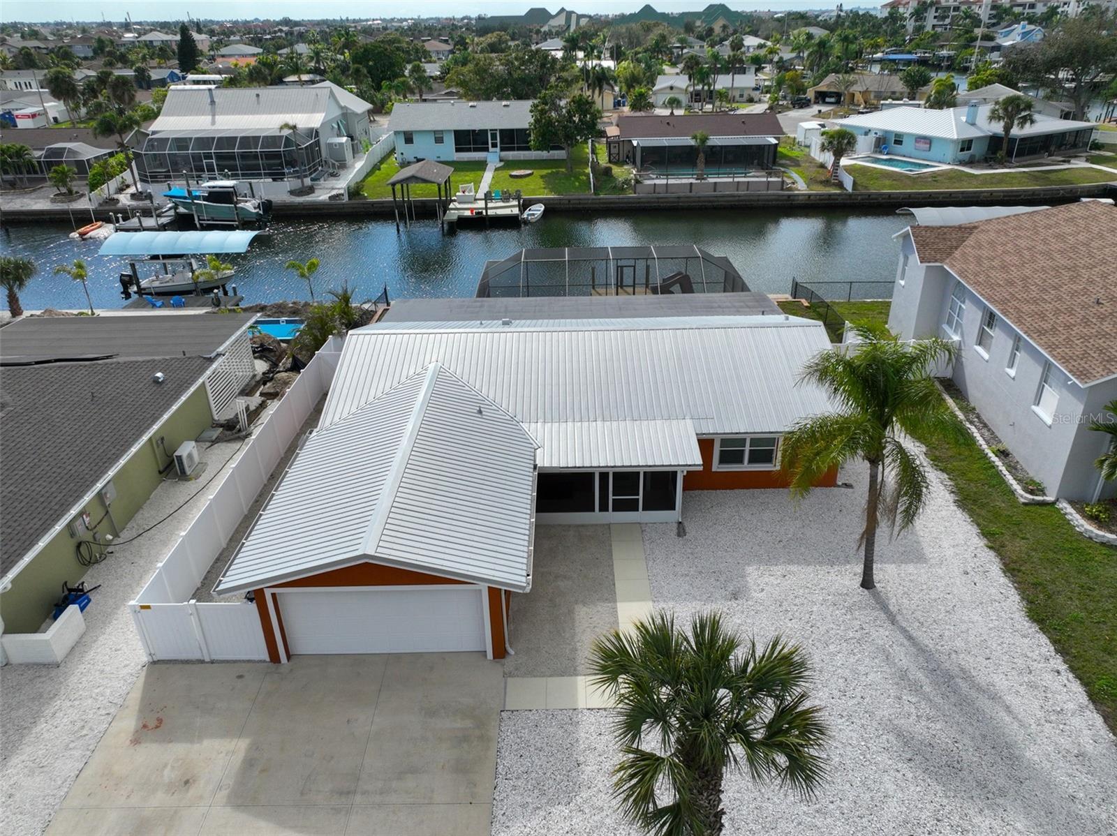 Stunning waterfront retreat with direct access to Tampa Bay within minutes in the heart of Apollo Beach. Over 75 ft of DEEP-WATER CANAL FRONTAGE with enhanced SEA WALL including returns (2018). NO HOA and NO CDD. This updated 3-bedroom, 2-bathroom home sits on an oversized lot along a deep-water canal, offering the ideal blend of luxury, comfort, and boating lifestyle. Enjoy your private oasis with a massive 50ft-covered screened lanai. Pool with recent marcite and tile including custom slide, perfect for fun, entertaining, or relaxing. The property has been remodeled including a METAL ROOF (2019). Fully remodeled kitchen with REMOTE BLINDS, GRANITE countertops, NEW STAINLESS appliances, huge ISLAND, updated sink with custom faucet, and cabinetry. The home also includes new LUXURY VINYL plank flooring throughout (2025) and modern custom finishes in both bathrooms including a jetted tub, fresh interior paint and doors. New HOT WATER HEATER, custom ceiling fans, and light switches throughout. Outdoor enhancements include a fully FENCED YARD, DOG AREA, private COURTYARD area with a convenient exterior storage shed for boating and pool supplies. Complete MAINTENANCE FREE Florida-friendly hard landscaping. The primary suite and bath offers a large shower and modern appointments with direct access to the pool and patio for seamless indoor-outdoor living. Located near major arteries for an easy commute to MacDill AFB, downtown Tampa, Brandon shopping, Ellenton outlets, top-rated hospitals, restaurants, and some of the best beaches in the country. An ideal waterfront retreat for a primary residence, vacation home, or short-term rental opportunity. Don't forget to check out the virtual tour!