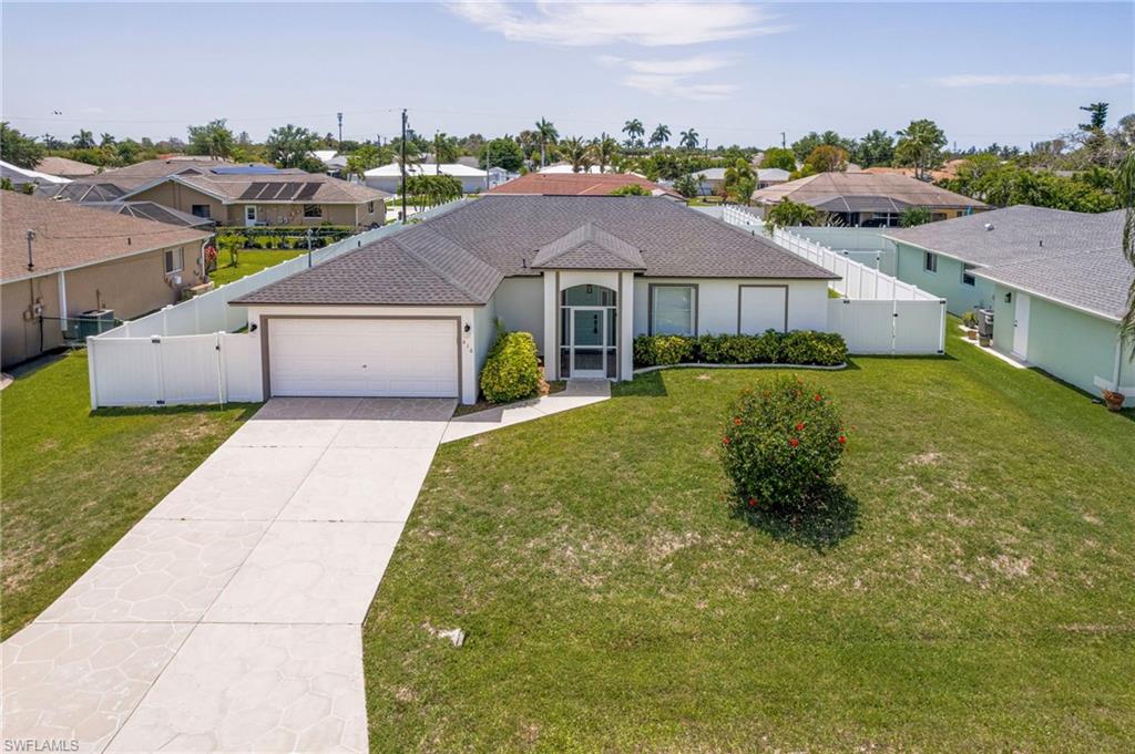 One or more photo(s) has been virtually staged, AI generated or rendered.  Beautifully updated home in highly desirable SE Cape Coral with NO HOA! Recently remodeled and move-in ready, this home offers peace of mind with a NEW ROOF, NEW A/C, luxury vinyl plank flooring, and NEW carpet in the bedrooms. The thoughtfully designed interior features two fully renovated bathrooms, an upgraded laundry room with cabinetry and utility sink, and a modern kitchen showcasing Cambria quartz countertops with a lifetime warranty, under-cabinet lighting, and a high-performance cooktop. Additional upgrades include a new washer and dryer, dimmable lighting throughout, accordion hurricane shutters, and numerous other thoughtful improvements.Step outside to a spacious, fully fenced backyard with mature fruit trees, a tiled lanai perfect for relaxing or entertaining, plenty of room to add a pool, and a 220V outlet ready for an EV charger, workshop, or future outdoor projects.Nestled in a quiet, established neighborhood with convenient access to shopping, dining, schools, and major roadways, this home combines comfort, style, and functionality. Highly motivated seller willing to work with buyers. Don't miss this incredible opportunity!