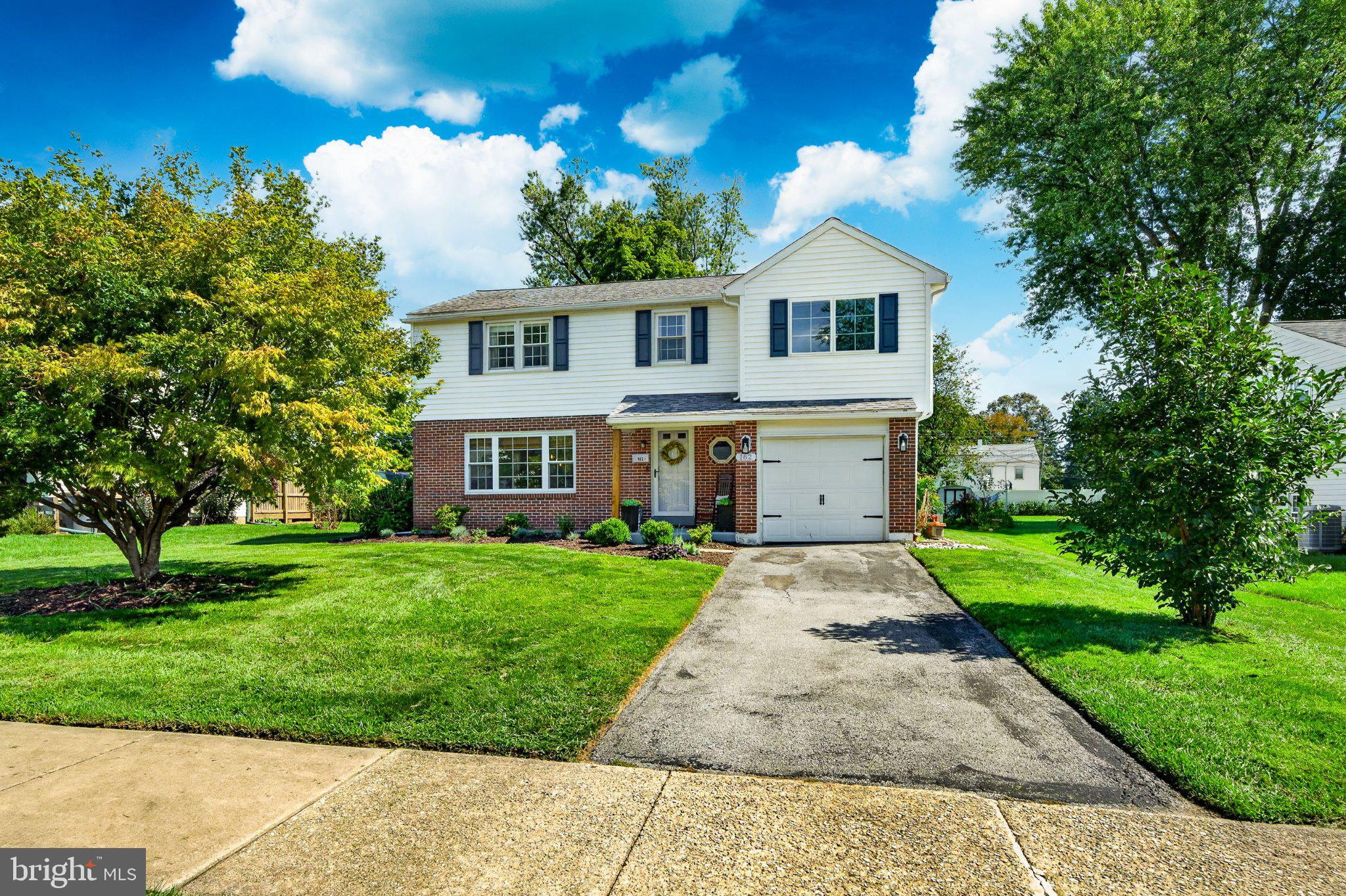 Welcome to 162 Lake Drive, a stylish and personality-filled 4-bedroom, 2.5-bath home offering approximately 1,639 square feet of living space, a finished lower level, one-car garage, and a fantastic backyard in a convenient Downingtown location. From the moment you step inside, this home feels anything but cookie-cutter. Hardwood floors run through much of the main level, while rich colors, custom-style wall treatments, updated lighting, and thoughtful details give the home a fresh, modern feel. The spacious living room is filled with natural light from the large front windows and features statement floral wallpaper paired with deep green board-and-batten detailing for a look that is both trendy and inviting. The living space flows into the dining area and updated kitchen, creating an easy layout for everyday living and entertaining. The kitchen features crisp white cabinetry, granite countertops, stainless steel appliances, recessed lighting, a farmhouse sink, and plenty of workspace and storage. Just beyond, the dining area offers direct access to the rear deck, making indoor-outdoor entertaining a breeze. A convenient powder room completes the main level. Upstairs, you'll find four bedrooms, including a generously sized primary bedroom with plenty of room to create your own retreat. The additional bedrooms offer flexibility for sleeping space, a home office, playroom, or whatever suits your needs. The home's full bathrooms have also been refreshed with updated vanities and contemporary finishes, including a double-sink vanity. Need even more room? The finished lower level adds valuable flexible living space with multiple areas that can easily accommodate a family room, gaming area, home office, workout space, hobby room, or guest accommodations. Outside may be one of the home's best surprises. Step from the dining area onto the spacious rear deck, with plenty of room for both outdoor dining and a separate conversation area. Beyond the deck is a large, level backyard with mature trees and plenty of open lawn for gardening, games, pets, entertaining, or simply enjoying time outdoors. All of this is tucked into an established Downingtown neighborhood with sidewalks and mature trees, while keeping you close to local parks, recreation, shopping, dining, and the everyday conveniences of the Downingtown area. With flexible living space inside, a backyard made to be enjoyed, and a style all its own, 162 Lake Drive is ready to welcome you home!!