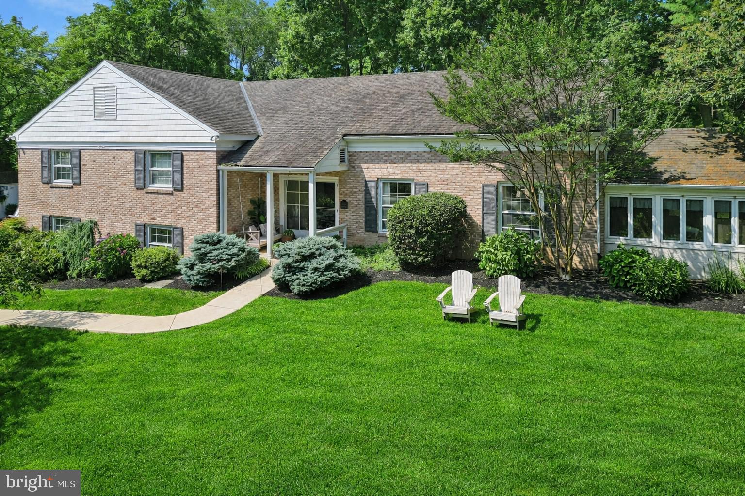 Welcome to 770 Robinhood Road, a beautifully maintained split-level home set on a private acre in the highly sought-after Beaupre neighborhood of Bryn Mawr.  Located on a quiet, tree-lined street within the award-winning Radnor Township School District, this home offers the perfect blend of timeless character, thoughtful updates, and exceptional space—an ideal setting for everyday living and entertaining.You are welcomed into the spacious foyer, complete with hardwood floors and a generous coat closet.  The traditional Living Room features hardwood floors and charming built in bookshelves.  This room flows into a sunroom—currently used as a kids’ art space and playroom but also ideal as a home office or gym. The kitchen is the heart of the home with light cabinetry, convenient island, granite countertops, and GE Monogram appliances.  An additional island with seating for eight adjoins the dining room, entertaining perfection!  This level is completed by a family room full of natural light that flows seamlessly onto the patio via sliding glass doors.The upper level features a gracious landing and four spacious bedrooms. The primary suite offers a walk-in closet and an updated bath designed for both function and relaxation, complete with a frameless glass shower, soaking tub, radiant floor heating and dual vanities. A renovated hall bath with custom cabinetry and stone surfaces serves the additional bedrooms.  The top level provides flexible living space with a private bedroom and sitting area—ideal for guests, a home office, or an au pair suite.The walk-out lower level includes a large family room with a brick fireplace, a full bath, and direct access to the driveway and two-car attached garage.The backyard is a true retreat, featuring a custom E.P. Henry patio with retaining wall, built-in fire pit, and ambient lighting—perfect for hosting or unwinding in a serene, park-like setting.  Additional recent upgrades include a new HVAC system and a tankless water heater, offering comfort and efficiency for years to come. This home’s ideal location is just minutes from parks, shopping, dining, several local hospitals, universities and major commuting routes.