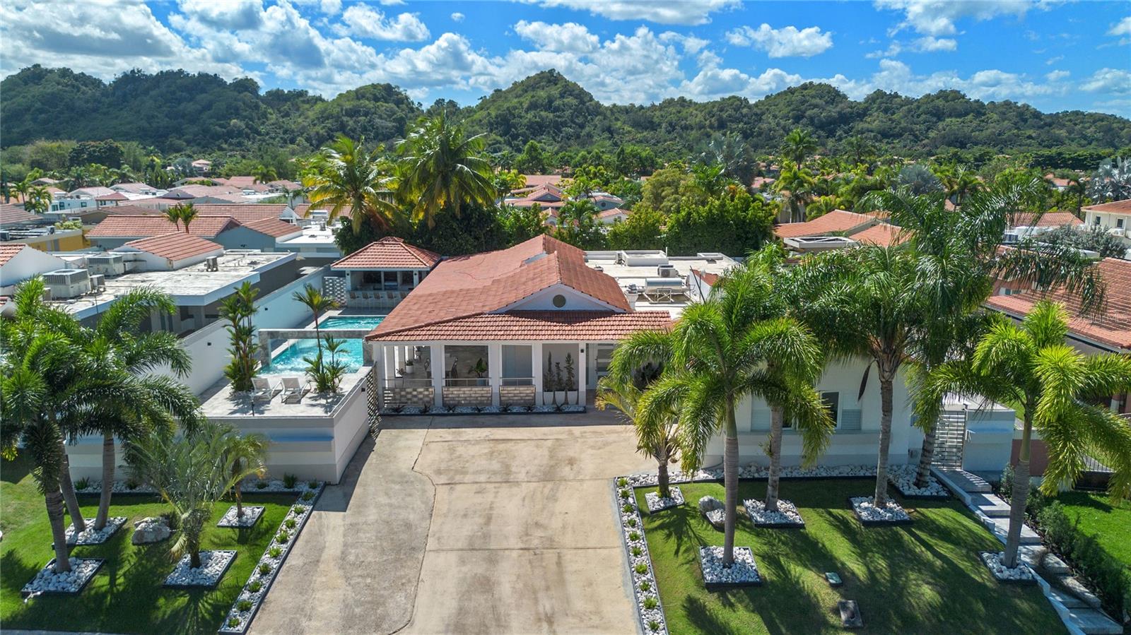 Located within the resort-style Sabanera Dorado community, this exceptional Extended Casona Reyes estate offers luxury one-story living with premium upgrades throughout. This completely furnished, turn-key residence combines elegant design, smart home technology, and resort-style outdoor living.The home features 4 bedrooms, 3 full bathrooms, and 2 half bathrooms, with 5,423 square feet of total construction and 3,413 square feet of interior living space, situated on an  937 square meter lot.Outdoor amenities include a heated saltwater pool with waterfall, extended terrace, full outdoor kitchen with Built-in BBQ with Masonry Exhaust Hood , stove, ice maker, 85” outdoor Frame TV, and a private artificial turf putting green. The home also includes a Control4 smart home system, integrated sound system, and two wine refrigerators.Infrastructure features include a 40 kW Caterpillar diesel generator, 1,200-gallon cistern, solar water heater, alkaline water filtration, and water softener system.Includes 2-car garage plus driveway parking for up to 6 additional vehicles.Appraised at $2,400,000 | Offered at $2,375,000 Sabanera Dorado is a resort-style gated community offering a clubhouse, fitness center, swimming pool, tennis courts, basketball and volleyball courts, soccer field, scenic walking and biking trails, Pergola Cafe mini market and on-site dining at La Pérgola Restaurant. The community is also home to TASIS Dorado – The American School of Puerto Rico, making it one of the most sought-after residential communities on the island.