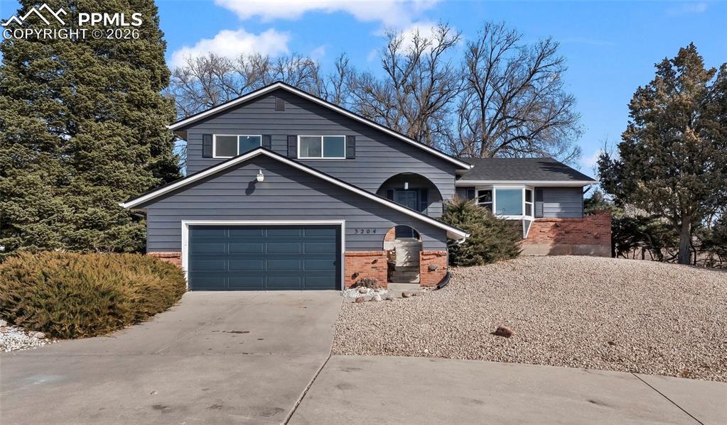 Welcome to your own private sanctuary in the coveted Valley Hi Golf Course Subdivision. Tucked at the edge of the golf course, this beautifully renovated home offers magnificent views of Pikes Peak. Set on a generous 0.33-acre lot with mature landscaping & exceptional curb appeal, the property features a graceful circular driveway & serene, park-like surroundings. Step inside to discover a light-filled, modern interior finished with thoughtful elegance: Dramatic vaulted living room with exposed original wood beams, cathedral arches, luxury vinyl plank flooring & a large bay window with views! The formal dining room ideal for gatherings. Reimagined kitchen featuring 42" cabinetry, sleek quartz countertops, brand-new stainless steel appliances & a sunny breakfast nook. Upstairs you’ll find a generous primary suite boasting a spacious walk-in closet and a luxurious en-suite bath w/ a walk-in rain shower & breathtaking mountain views. Two additional bedrooms & a full bath complete the upper level. The lower level offers a warm family room w/ a classic brick fireplace, half bath & mini-bar area. The finished basement provides excellent flexibility: a large rec room/flex space plus an additional bedroom. Outside, the backyard feels like your personal Colorado retreat: Xeriscaped w/ low-maintenance beauty, a large composite deck under a stylish pergola & ample space for relaxation and entertaining. A second oversized driveway at the rear easily accommodates extra vehicles, an RV or boat. Recent high-quality updates: Brand-new roof class 4 hail-resistant shingles, New Windows, interior and exterior paint, Luxury vinyl plank floors, new carpet, remodeled bathrooms, modern glass lighting fixtures. Located at the Valley Hi Golf Course & Clubhouse, this rare combo of privacy, VIEWS, modern upgrades & golf-course proximity !