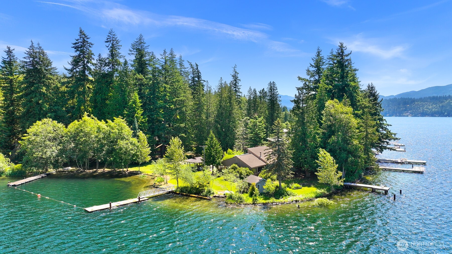 Lake Whatcom dream estate featuring 2 homes on 3.1 acres. Situated on the iconic sun-soaked north shore with 900' of low bank, sandy waterfront. Plenty of moorage for fun lake toys with 3 docks & a boat ramp. This rare private enclave also includes 4 additional cabins, 1 fully finished as an ADU. Flat lot, facing due west with all day sun and endless sunsets. Near the base of a major trail system & mountain bike paths. Contemporary main home features 3 bed, 2.5 bath that is positioned with 180 degree lake views from every room. 2nd home sits directly at the waters' edge on its own separate parcel with 2 bed, 2bath & loft. This extraordinary property offers an idyllic lifestyle which is truly beyond compare.