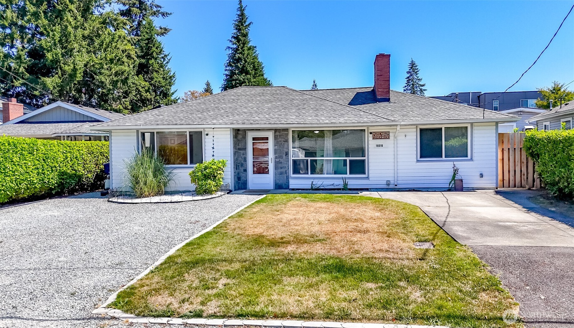 Welcome to this move-in ready 3-bedroom,1.5-bath Burien home offering 1,600 square feet of comfortable living space. Through the entry is a versatile flex room or living room with a wood burning fireplace. The heart of the home is a huge family room featuring vaulted ceilings, skylights, a cozy gas fireplace,1/2 bath, large storage closet or media room & new carpet. Efficient radiant floor heating in the rest of home keeps things warm and comfortable. A generously sized mudroom adds even more convenience that includes a laundry area, plenty of storage & separate entrance. From the Family room, step out of the brand new French doors to the patio area and yard complete with a play set and space to enjoy the outdoors. At the back of the property is your hobbyist or mechanic's dream! The 480 square foot detached shop comes fully equipped and loaded with a gas heater, air compressor, overhead crane, a heavy-duty workbench and brand-new garage door. Property includes an additional 10x25 storage building that with the proper approvals and permits could be converted into a (DADU) if desired—perfect for rental income, a home office, or a private guest Studio. This home is nestled in a highly convenient neighborhood just minutes from St. Anne Hospital. Commuters will love the short, easy drive into downtown Seattle for work, dining, and entertainment. Don't miss this rare property with endless possibilities! Properties like these don't last long!