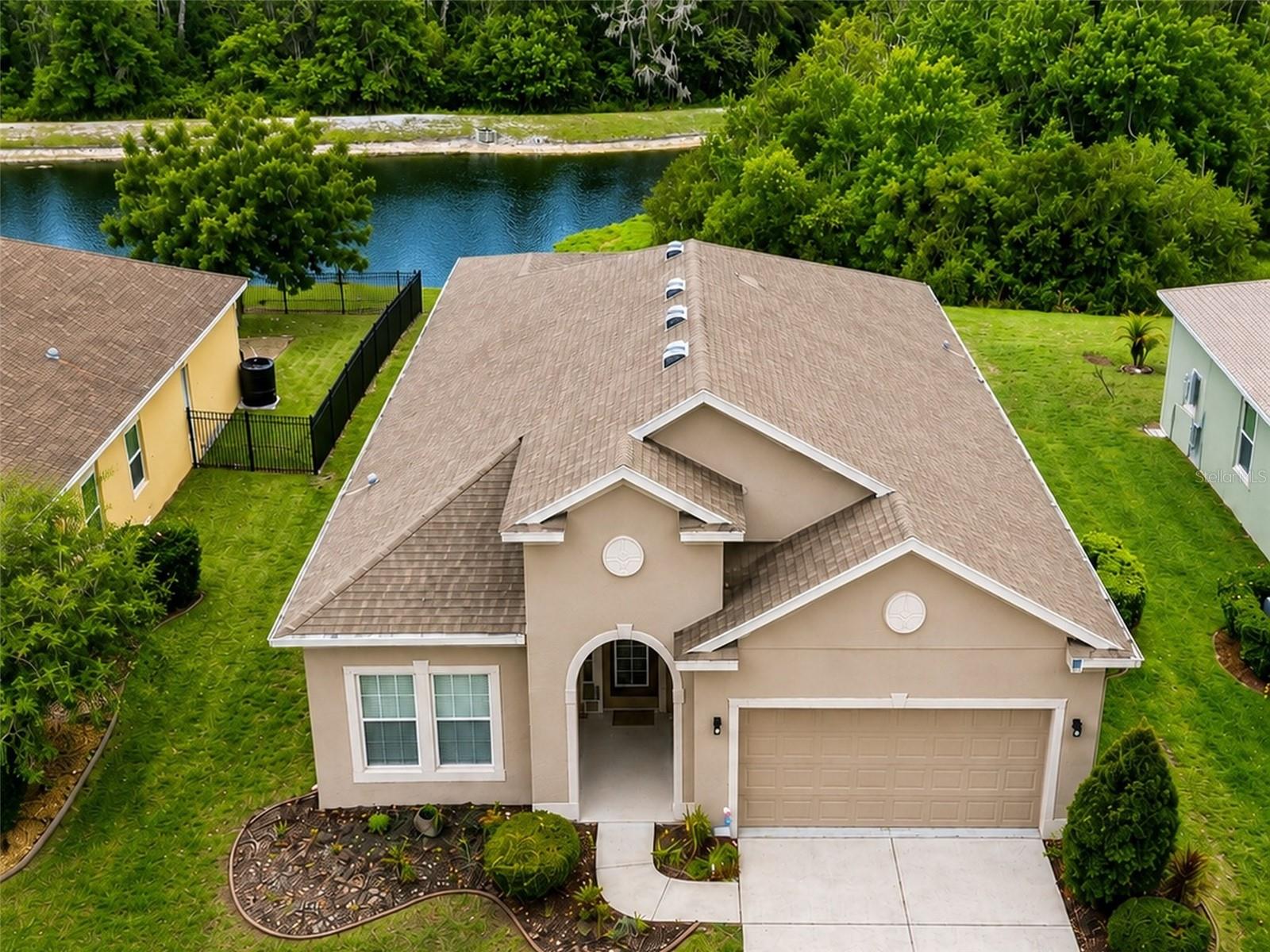 WELCOME TO PARADISE IN WATERS EDGE! Nestled on a premium conservation homesite with no rear neighbors, this beautifully maintained 4-bedroom, 2-bathroom home with a 2-car garage offers the perfect combination of privacy, comfort, and resort-style living. From the moment you arrive, you'll appreciate the pride of ownership throughout. Step inside to discover an inviting open floor plan featuring newer wood flooring throughout the main living areas, tile in all wet areas, abundant natural light, and a layout designed for both everyday living and entertaining. The spacious kitchen opens seamlessly to the living and dining areas, creating the ideal gathering space for family and friends. The split-bedroom floor plan provides privacy for the owner's retreat while offering generous secondary bedrooms for family, guests, or a home office. Step outside and enjoy your own private backyard oasis overlooking peaceful conservation views. With no rear neighbors, you'll love relaxing with your morning coffee, entertaining guests, or simply enjoying Florida's beautiful weather in complete tranquility. Located within the highly desirable gated community of Waters Edge, residents enjoy an incredible collection of resort-style amenities including a spectacular clubhouse, state-of-the-art fitness center, resort-style swimming pool, splash pool, playgrounds, basketball and pickleball courts, fishing piers, boat dock access, parks, walking areas, and numerous community activities throughout the year. Waters Edge is surrounded by natural beauty while remaining conveniently located near top-rated schools, shopping, restaurants, medical facilities, Starkey Wilderness Preserve, Gulf beaches, and the Suncoast Parkway for an easy commute to Tampa. Homes on conservation lots in Waters Edge are highly sought after and rarely available. This is your opportunity to own one of the community's most desirable settings while enjoying all the benefits of resort-style Florida living. Schedule your private showing today before this exceptional home is gone!