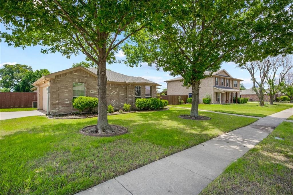 ONE STORY, COMPLETE REMODEL, MODERN DESIGN, HUGE YARD, NO CARPET! Discover an abundance of space in this beautifully remodeled one-story home! Enjoy easy-maintenance wood-like tile flooring throughout, complemented by a remodeled modern kitchen featuring new light fixtures, stainless steel appliances, apron sink, quartz countertops, marble backsplash, and grey and white cabinetry. The oversized and inviting living room is open to the kitchen and eat-in area, and boasts a floor-to-ceiling stacked stone gas fireplace and a modern fan.  This home also has a second dining area, which is versatile and can be used as an office or second living area. The primary retreat is spacious, with a remodeled primary bath complete with a new vanity with double sinks, new plumbing fixtures and vessel bowl sinks, a tile accent wall, separate tub, and separate shower with a rain shower system and glass tile accents, and spacious closet. The shared secondary bath is updated with glass tiles, warm gray tones, and a new vanity. Two additional bedrooms complete the floorplan. One secondary bedroom includes a new chandelier and bay window. Additional features include flat screen wiring, new light fixtures, and large closets. This home boasts a large lot, making entertaining a breeze with the oversized backyard and attached covered patio.