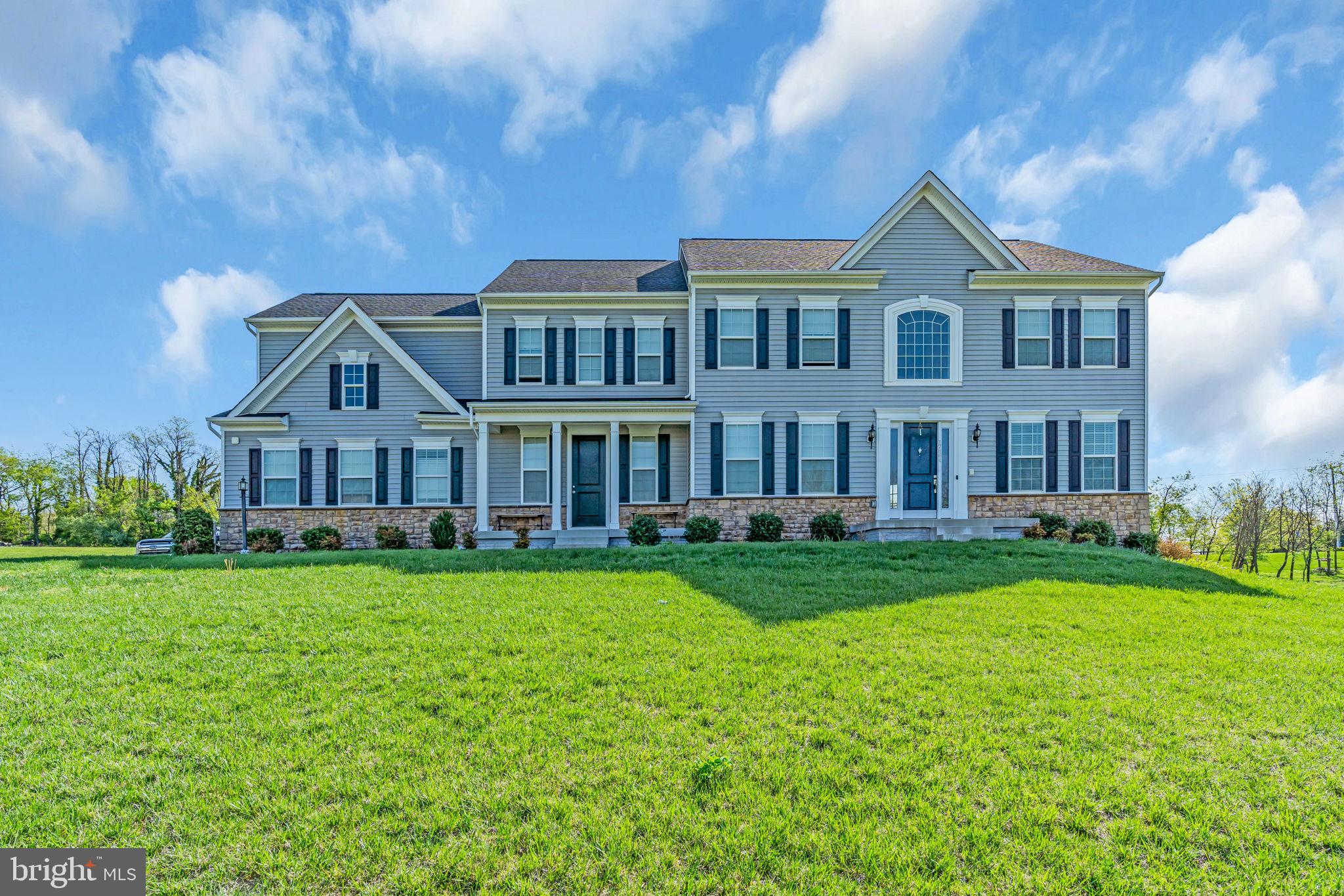 Welcome to this magnificent Craftsman-style estate nestled in the prestigious Jacksons Run community, surrounded by the picturesque rolling hills of Purcellville. This stunning residence boasts 5 spacious bedrooms, 4 full bathrooms, and nearly 5,000 square feet of refined living space above grade. The heart of the home is a gourmet kitchen, thoughtfully designed with custom quartz countertops, high-end stainless steel appliances, and seamless access to an expansive Trex deck—nearly 1,000 square feet—offering a breathtaking natural backdrop perfect for entertaining or relaxing. Rich solid wood floors grace the main level and staircase, leading into an immaculate two-story foyer and an elegant family room highlighted by a grand gas fireplace and soaring Palladian windows that flood the space with natural light. The upper level features a luxurious primary suite with a spa-inspired shower and two additional bathrooms, while the main level offers the convenience of a full walk-in shower in the powder room. Set on nearly two acres, this home also includes a side-load two-car garage, an extended driveway, and a stately portico entrance with a welcoming walkway. A truly exceptional property that blends timeless design with modern comforts—this home is a must-see.
