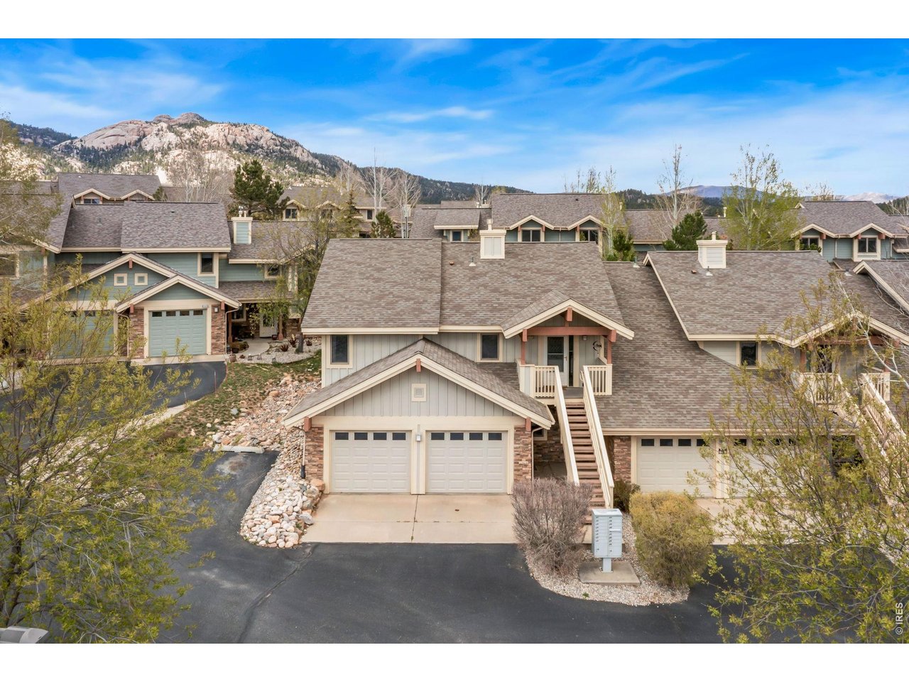 Mountain living that is just minutes from it all! This premier end-unit condo offers the perfect blend of nature and convenience, ideally located near Lake Estes and downtown with stunning mountain views and easy access to everything the area has to offer. Move-in ready with numerous upgrades including new LVP flooring, remodeled bathrooms, and brand-new appliances that give the home a fresh, modern feel throughout. Inside, the open flow is designed for everyday comfort, with the kitchen, dining, and living areas connecting seamlessly to create a layout that feels both spacious and functional. The living room features vaulted ceilings and a cozy fireplace, as well as direct access to the back patio that makes it easy to enjoy the mountain air. Whip up your favorite meals in the kitchen that features new stainless-steel appliances and new countertops. Two bedrooms are located on the main floor, including a primary suite with its own ensuite bathroom for added comfort and privacy. The partial garden-level basement includes an additional bedroom and bathroom, along with direct access to the attached 2-car garage. HOA coverage takes care of most outdoor maintenance, giving you more time to enjoy a lock-and-leave lifestyle, especially with a location that brings the outdoors to you. Just minutes from Rocky Mountain National Park, with easy access to Lake Estes Trail and Marina, downtown dining, breweries, and Riverwalk shops. Plus, enjoy worry-free living with a transferrable home warranty that provides comprehensive coverage for nearly everything inside the condo, offering true peace of mind.