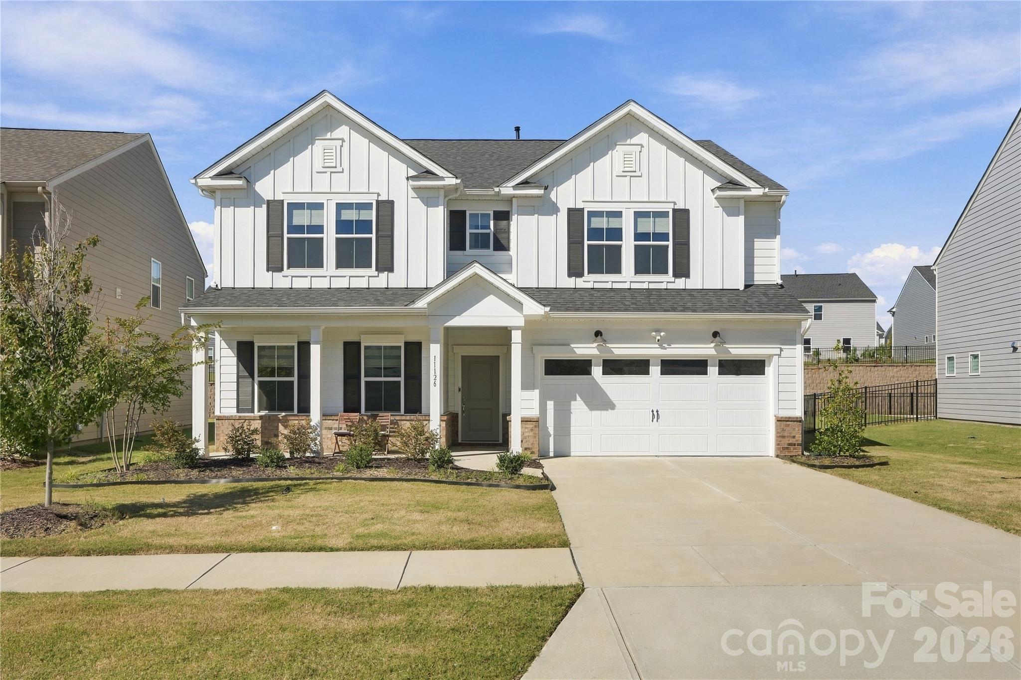 Better than new construction! Welcome to 11126 Glasden Road in desirable Parkside Crossing,  premium upgrades, and a spacious 0.21-acre homesite come together in Southwest Charlotte's popular Steele Creek area. Built in 2024, this meticulously maintained 5-bedroom, 3-bath home offers approximately 3,089 sq ft of thoughtfully designed living space with numerous builder-selected upgrades and additional owner improvements already in place. An inviting front porch, attractive curb appeal, and a larger, flat backyard create an appealing setting for everyday living and outdoor entertaining. Step inside to an open-concept floor plan connecting the spacious living, dining, and kitchen areas. The beautifully upgraded kitchen features an oversized center island, elegant quartz countertops, upgraded cabinetry, stylish tile backsplash, KitchenAid stainless steel gas appliances, under-cabinet lighting, and a dedicated filtered drinking water system with a separate faucet. Additional touches include upgraded window treatments with convenient remote-operated blinds in the living room, recessed lighting, and beautiful oak stair treads with open Craftsman-style railing. A main-level bedroom and full bathroom featuring an upgraded tiled walk-in shower with grab bar offer exceptional flexibility for guests, a private office, or multigenerational living. Upstairs, the spacious primary suite includes an oversized walk-in closet and upgraded ensuite bathroom with a tiled walk-in shower and built-in seat. Three additional bedrooms, a versatile loft perfect for a media room or second living area, and a conveniently located laundry room complete the upper level. Additional highlights include quartz bathroom countertops, a tankless water heater, and upgraded finishes throughout. Enjoy the lifestyle and amenities of Parkside Crossing, with convenient access to RiverGate Shopping Center, Charlotte Premium Outlets, McDowell Nature Preserve, Lake Wylie, and Charlotte Douglas International Airport. Why start from scratch with new construction when you can enjoy a beautifully maintained 2024 home with premium upgrades, custom window treatments, a filtered drinking water system, and a generous 0.21-acre lot with a flat, usable backyard. HOA-Included 1 Gig Internet. Discover the space, comfort, and convenience that make 11126 Glasden Road stand out. Schedule your private showing today!