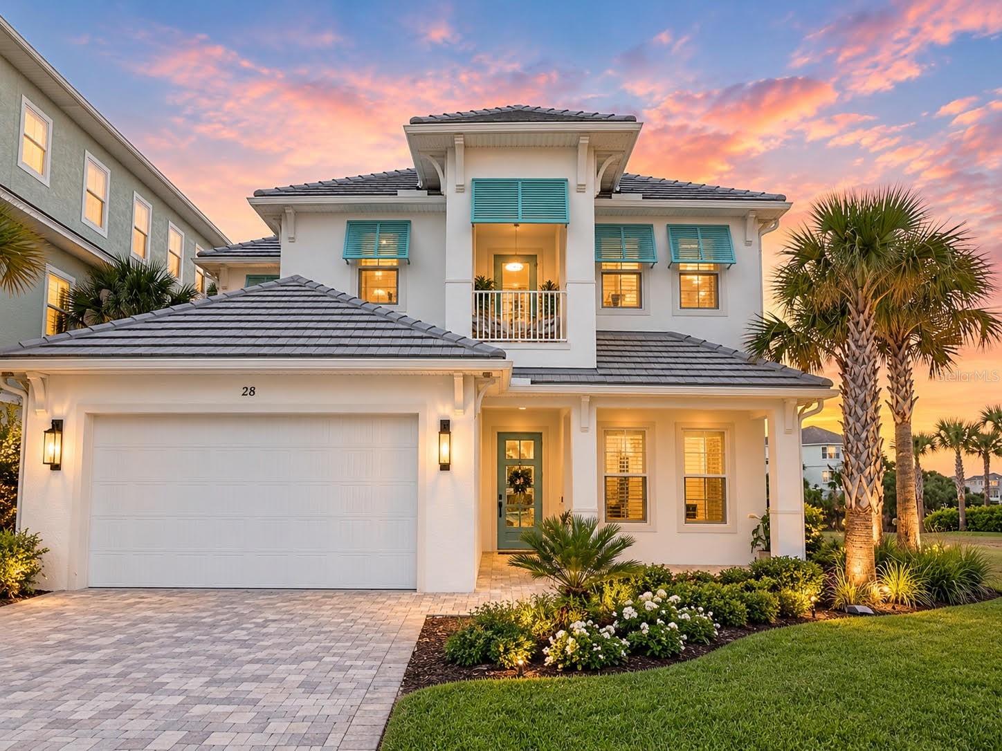 Enjoy coastal living at 28 Cinnamon Beach Way, a newly constructed six-bedroom, five-bath lakefront pool home in the gated community of Cinnamon Beach at Ocean Hammock. Upgraded finishes, multiple gathering spaces and accommodations for up to 12 guests make this property ideal as a primary residence, second home or vacation rental. Morning coffee overlooking the lagoon, afternoons beside the private heated pool and evenings under the covered lanai capture the relaxed luxury of beachside living.White stucco, blue-green Bahamian-style shutters, a tile roof and a second-story balcony create distinctive coastal curb appeal. Mature palms, a paver driveway and a covered entry complete the welcoming exterior. Inside, wide-plank luxury vinyl flooring, 10-foot ceilings, recessed lighting and contemporary millwork complement the open floor plan. Dual tankless water heaters and a private enclosed outdoor shower add everyday convenience.Designed for entertaining, the kitchen features an oversized contrasting island with seating for four, glass pendant lighting, a walk-in pantry, abundant cabinetry, stainless-steel appliances and built-in double wall ovens. Open display shelving and a statement range hood with full-height tile detail provide a custom finish. The adjacent dining area flows into the spacious living room, where a linear fireplace with a dramatic floor-to-ceiling surround creates a striking focal point. Large sliding glass doors open to the granite-tiled pool deck, extending the living space outdoors.The first floor includes two bedrooms and two bathrooms. Overlooking the pool and lagoon, the primary suite features a luxurious bath with a dual-sink vanity, illuminated mirrors, warm brass fixtures and pendant lighting. Its oversized frameless-glass shower includes marble-look tile, pebble mosaic flooring, a built-in bench, rain shower and handheld fixtures.Upstairs, three additional bedrooms, two bathrooms and two balconies provide generous space for family and guests. A second living room showcases an ocean-inspired abstract mural, tray ceiling, oversized modern fan, custom built-in shelving and a large television, creating a comfortable gathering space.The expansive covered lanai offers room for lounge seating and outdoor dining beneath a large ceiling fan. Beyond it, the private heated pool overlooks the peaceful lake, framed by palms and coastal homes. Spacious covered and open-air areas provide inviting settings for swimming, entertaining and relaxing throughout the year.Approximately a five-minute stroll from the home, a picturesque footbridge crosses the lagoon toward Cinnamon Beach’s Atlantic shoreline. Residents and guests enjoy private beach access and resort-style amenities, including an oceanfront pool, a separate family-friendly pool complex, clubhouse, fitness center, children’s splash pad, game and entertainment spaces, and a seasonal café. Palms, lakes and walking paths enhance the community’s coastal setting.For buyers seeking vacation-rental potential, this home combines desirable features: a private pool, lakefront views, multiple living areas, spacious accommodations and substantial outdoor living space within an established vacation-rental community. Whether enjoying it year-round, escaping for a coastal getaway or exploring rental income opportunities, 28 Cinnamon Beach Way offers an exceptional setting to experience the Cinnamon Beach lifestyle.