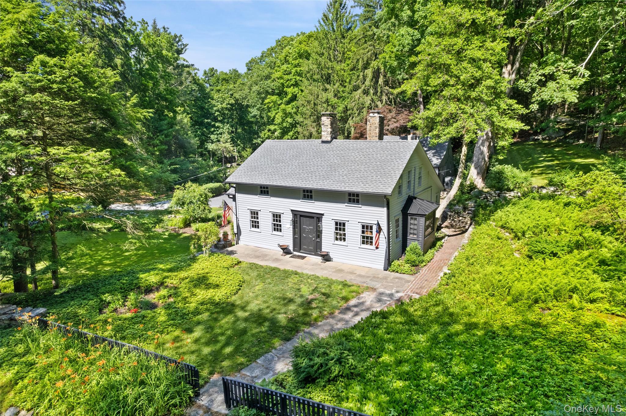 Antique lovers... A near impossible to find rare gem set on a small quiet back road of only a handful of homes - step into the timeless charm of the landmarked Sarles-Bode house, a quintessential c.1750 home in Pound Ridge, NY. This is a rare offering where timeless character and everyday livability come together in the main house, guest house, gunite pool and extensive outdoor entertainment areas. Layered with history, the original 18th-century main residence, later expanded in both the 19th and 20th centuries, retain its original charm throughout a complete and careful top to bottom renovation (2023-2026) This remarkable property showcases beautifully preserved wide plank flooring and hand hewn beams throughout the interior. The exterior is complemented by extensive dry stone walls, exceptional stonework patios, and amazing rock outcroppings. All rooms offer their own charm, highlighted by builts ins, bookcases and distinctive wooden doors- each with its own character and paired with original materials that create a true sense of history. The living room features a wood-burning fireplace and built-ins, while the dining room offers a second fireplace. The primary bedroom sits privately at the back of the main residence featuring his and her baths, a huge lounge area and amazing sunset views. The large 2 story guest cottage is private from the main house yet easily accessible to the pool and property featuring 2 full baths, a great room downstairs and oversized guest bedroom upstairs. Set on over 2 beautiful, private professionally landscaped acres, this one of a kind cherished residence seamlessly blends historic character with the modern-day comforts of today.